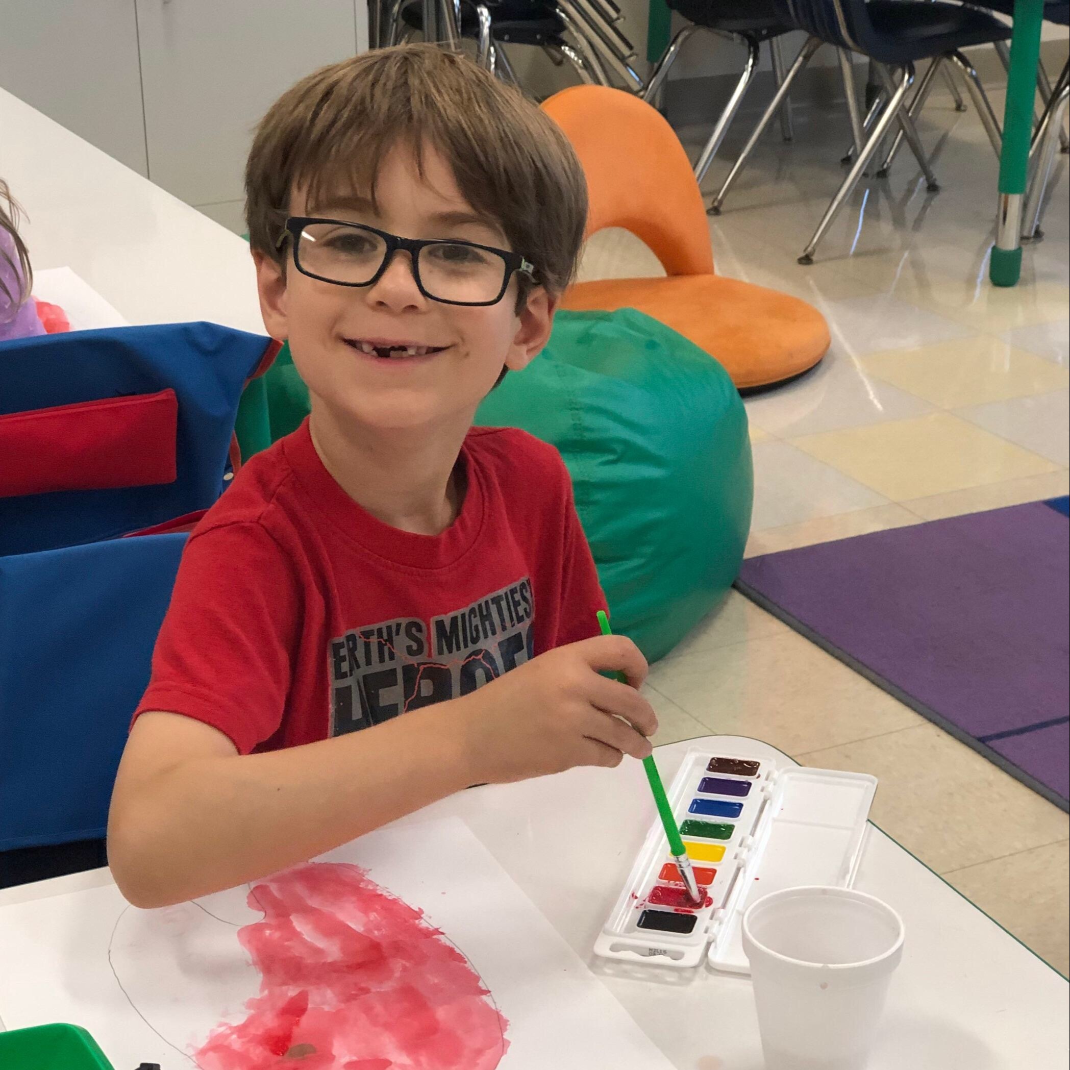 Student smiles while painting