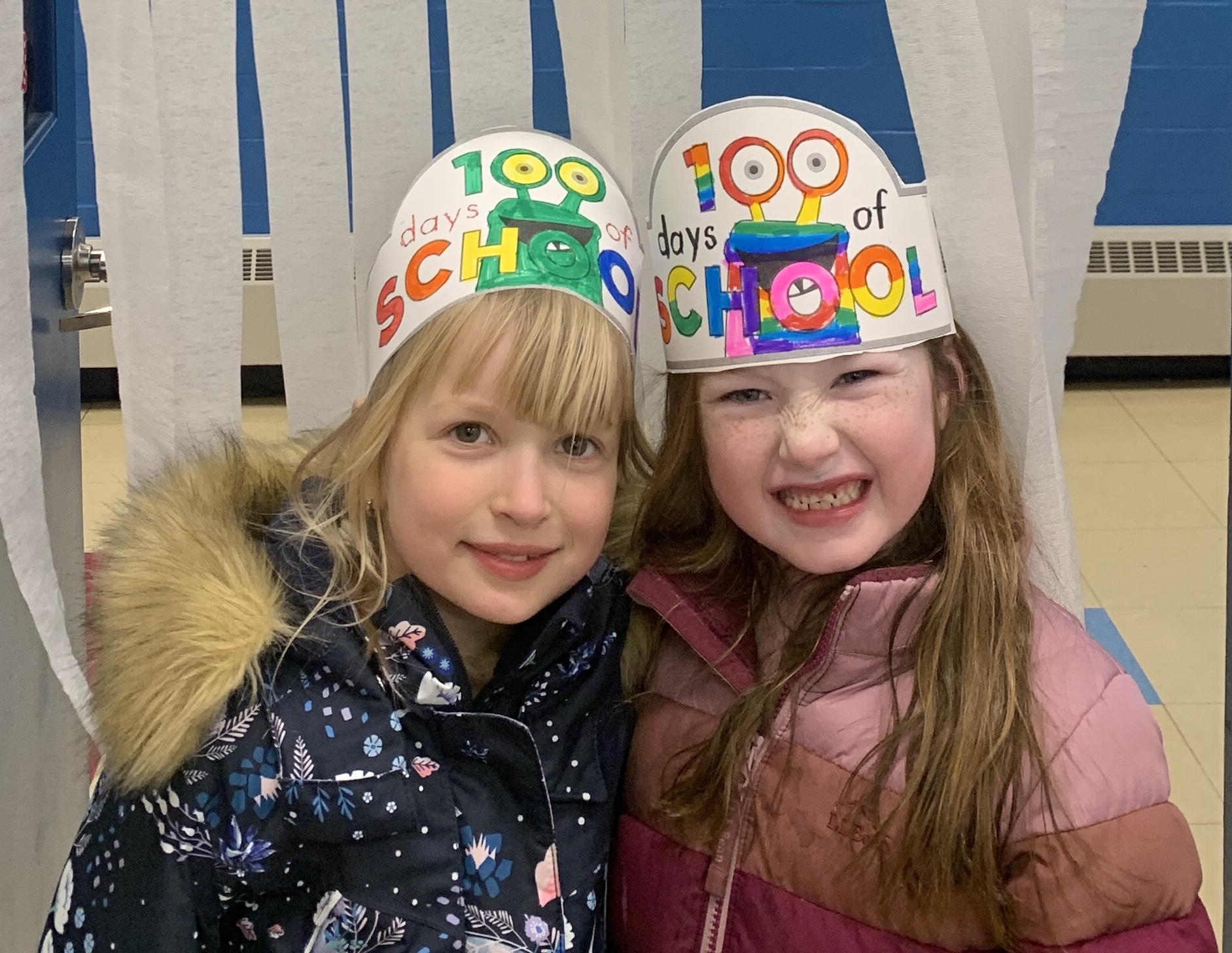 Students smile while wearing 100 day hats