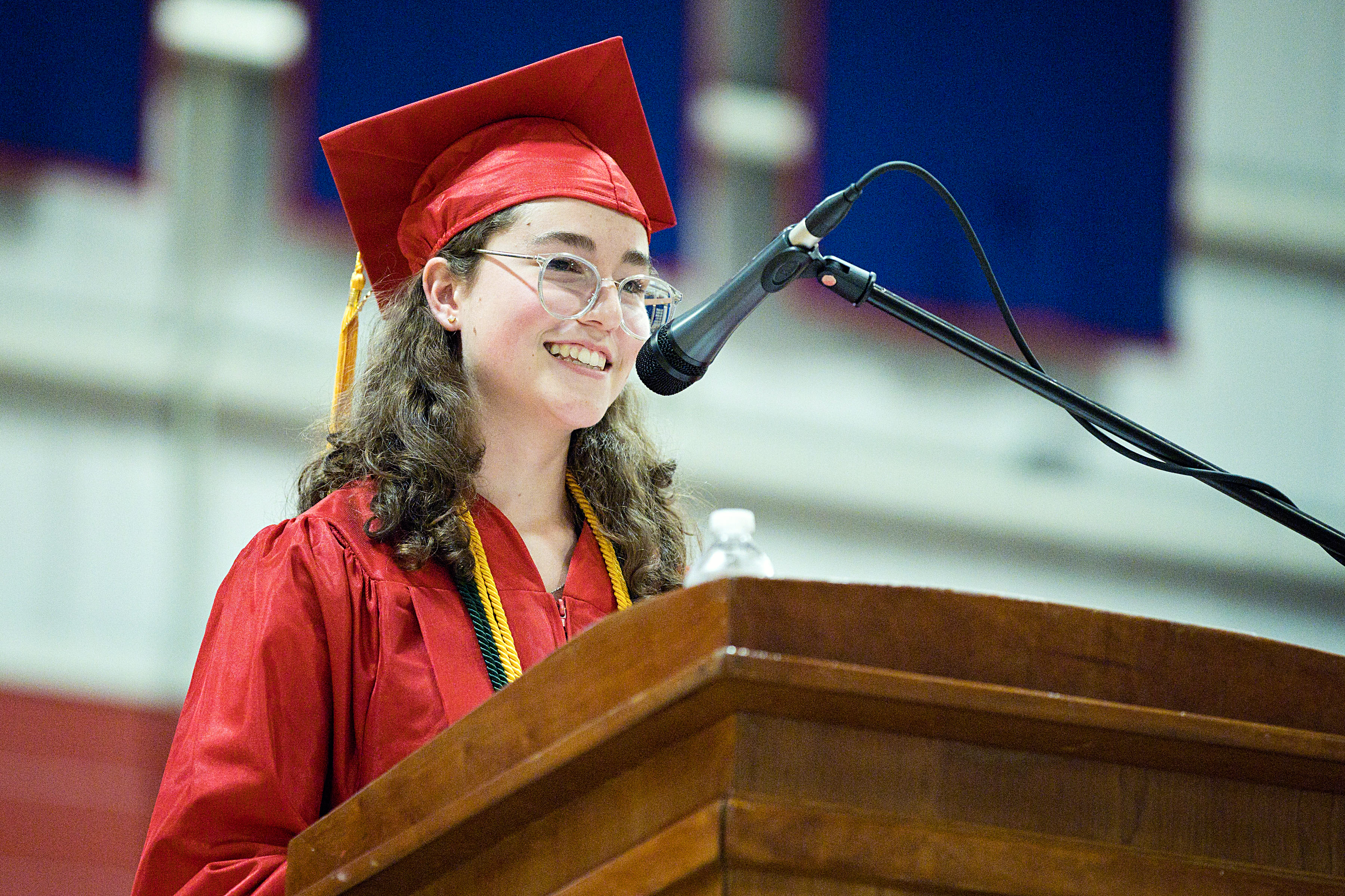 Girl Reading at Graduation Podium