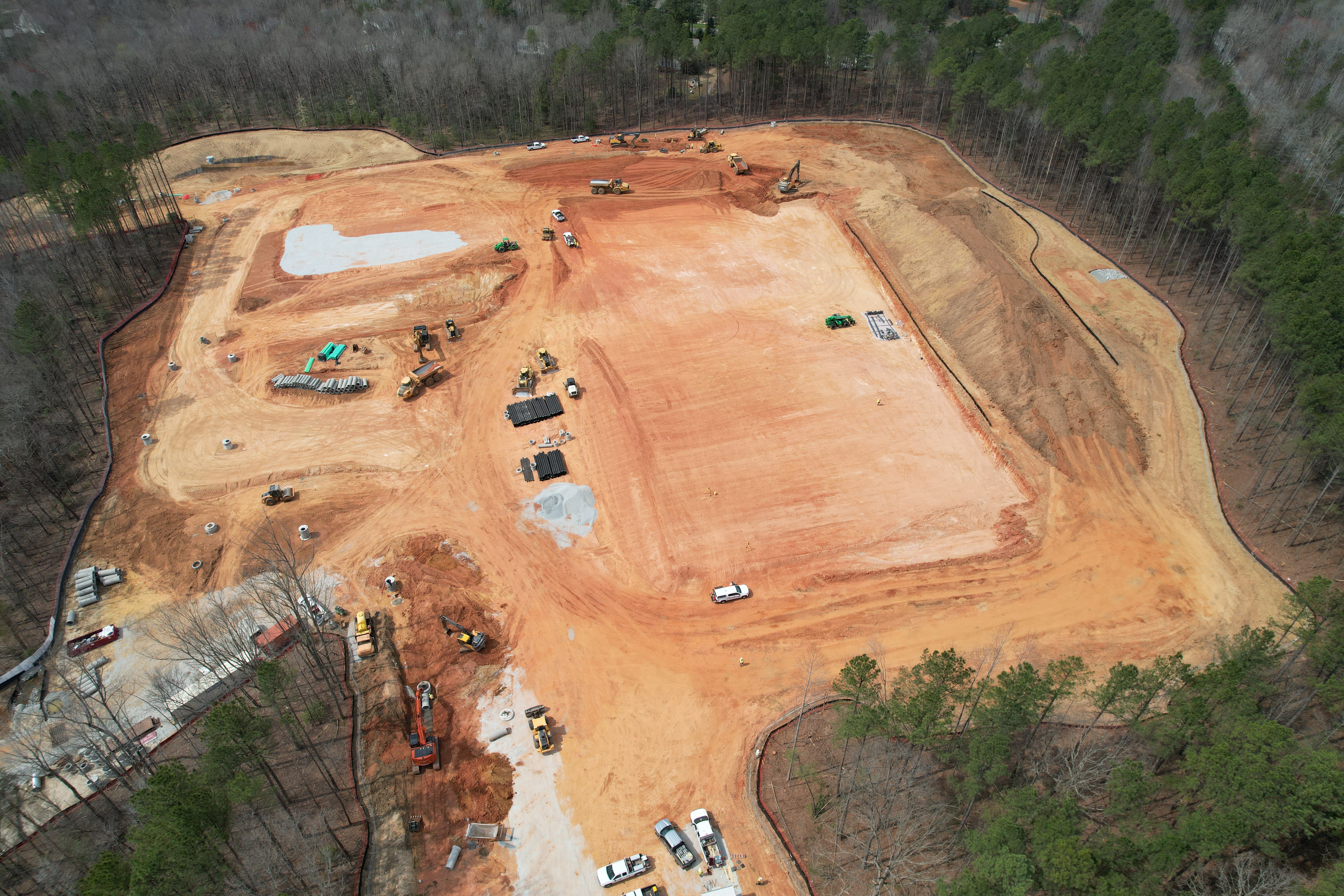 Drone image of new GES construction site with graded school pad clearly visible