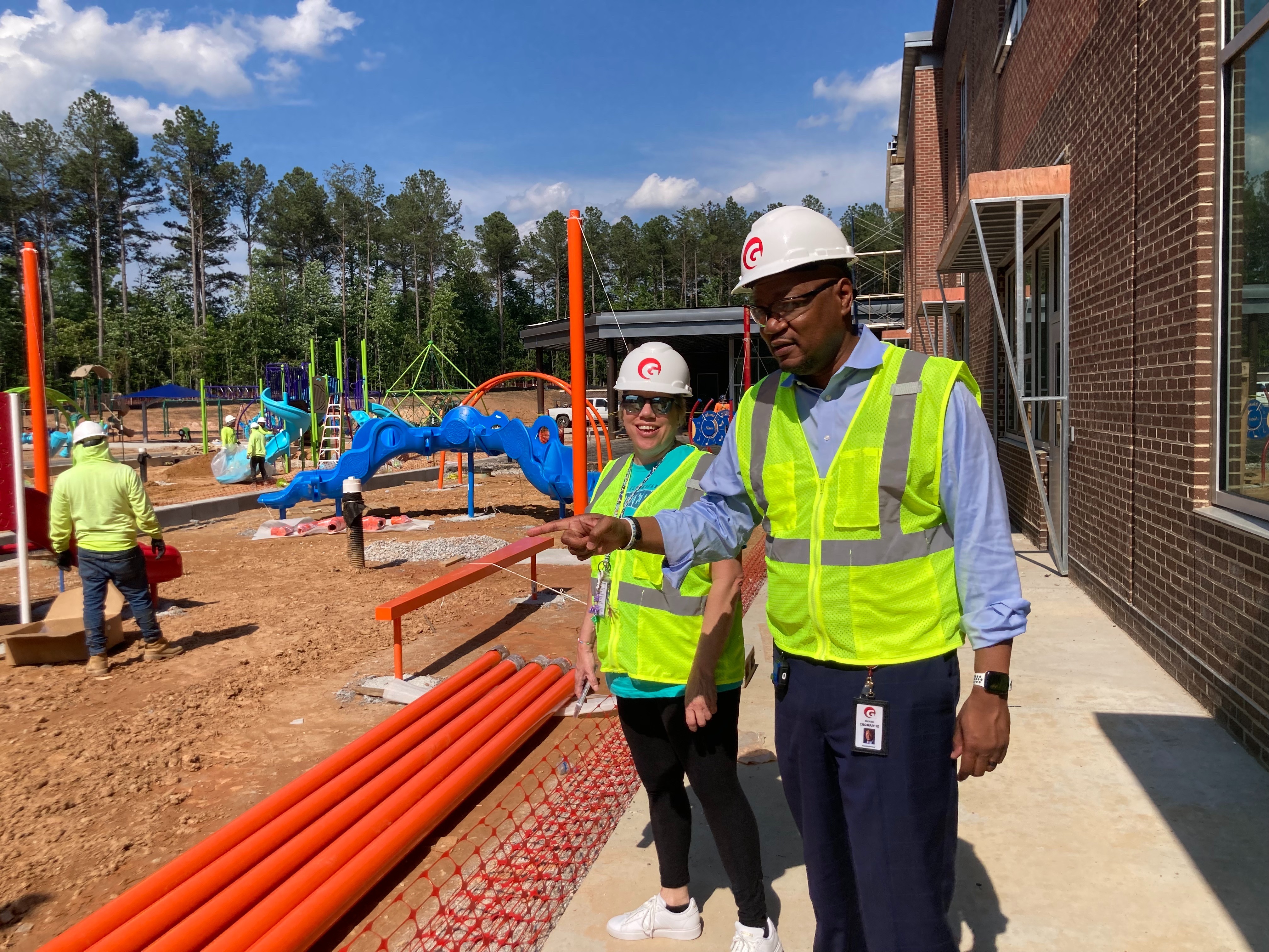 Principal McCay and Superintendent Cromartie check out the preschool play equipment as it was being installed.