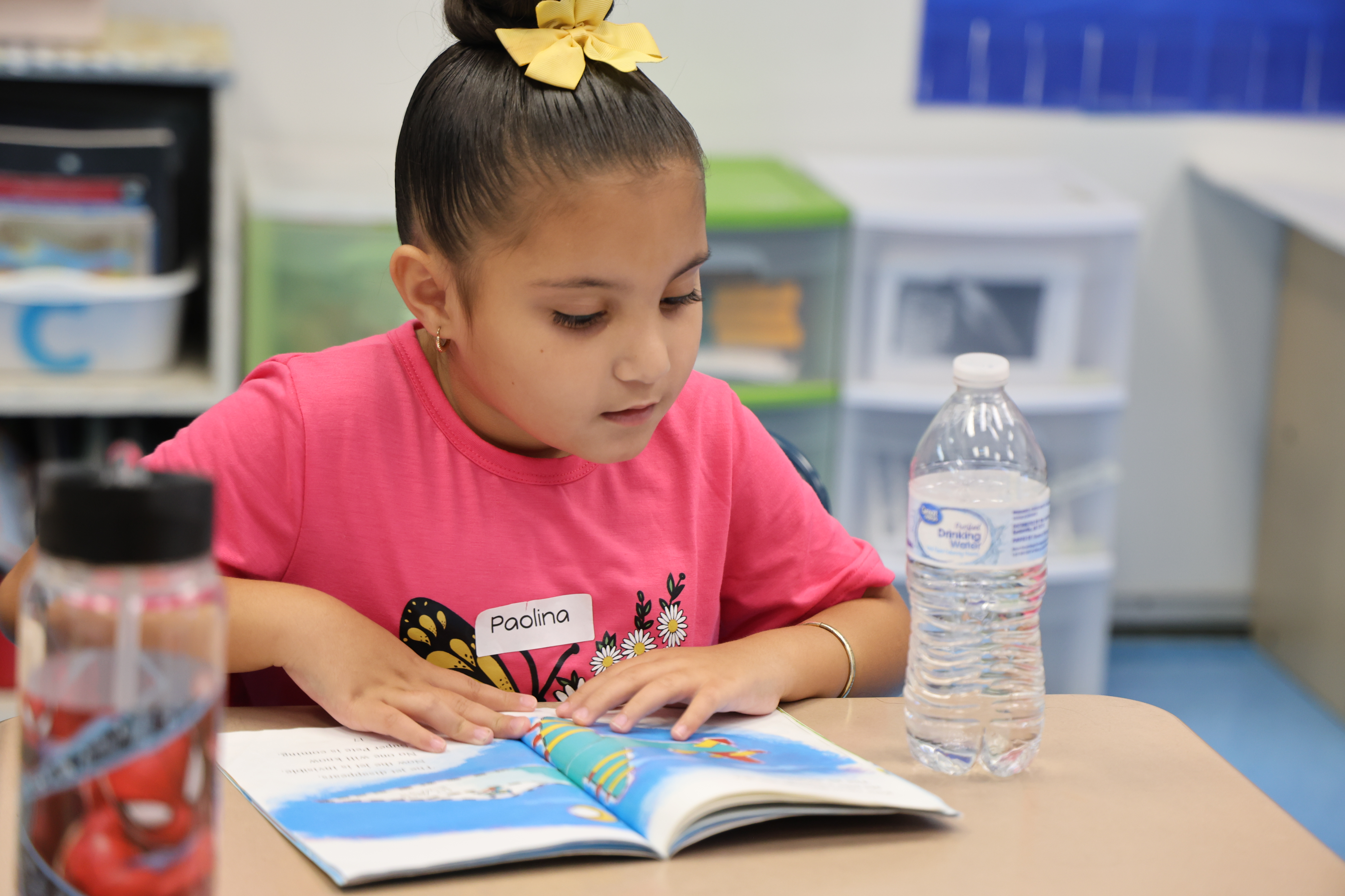 student reading in pink shirt