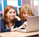 Two girls working on their computer