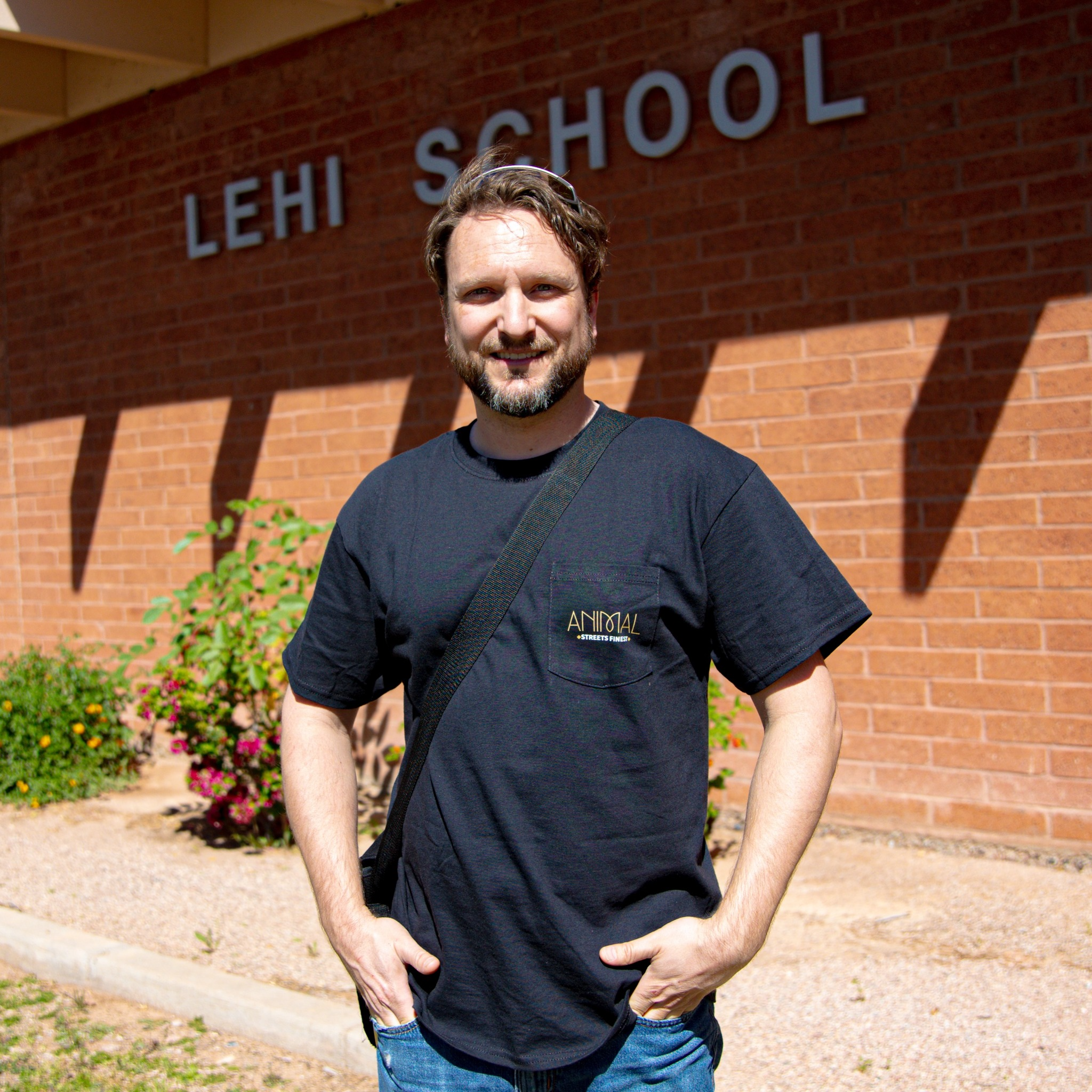 Lehi male volunteer standing in front of school
