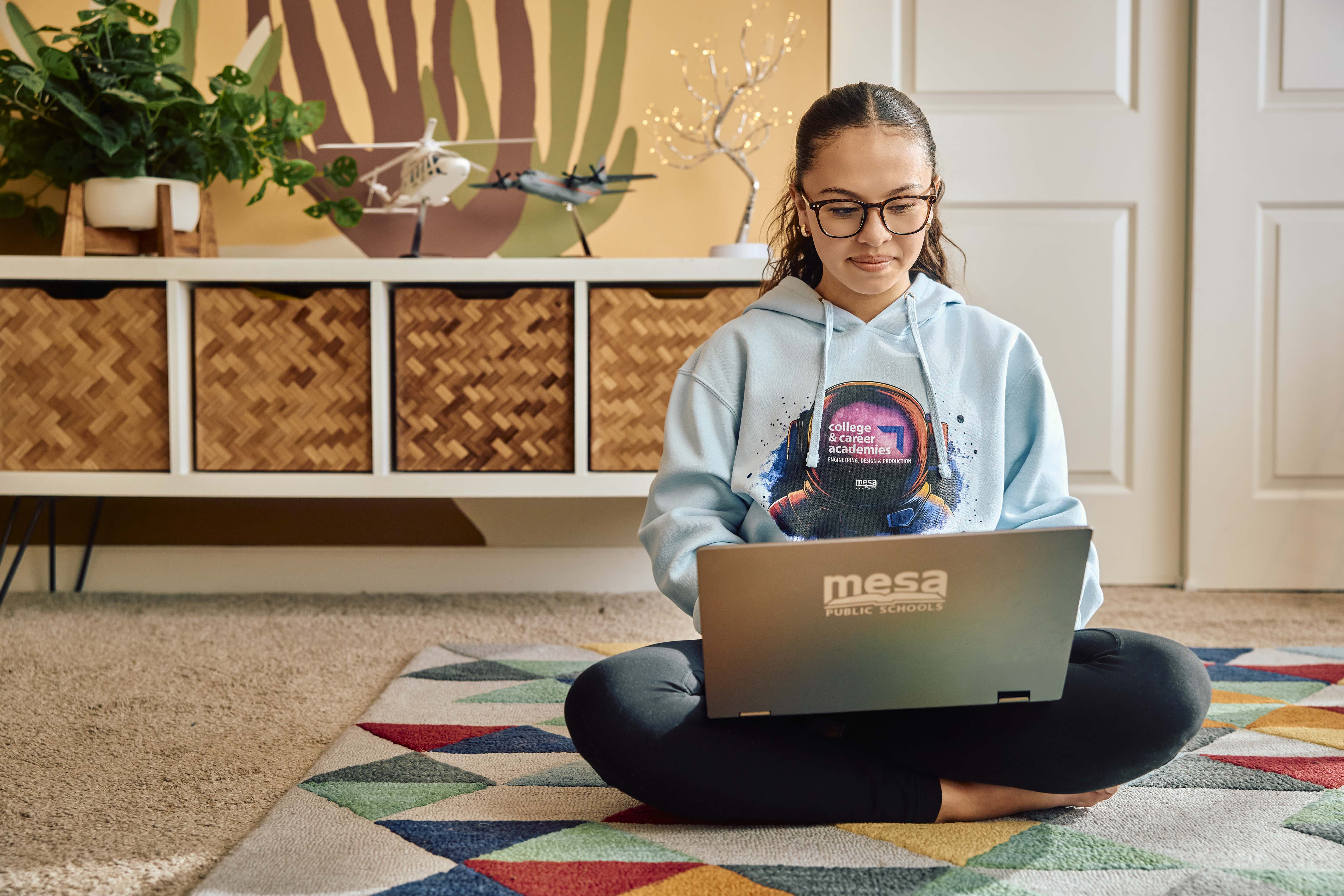Girl sitting at computer, learning about college and career academies