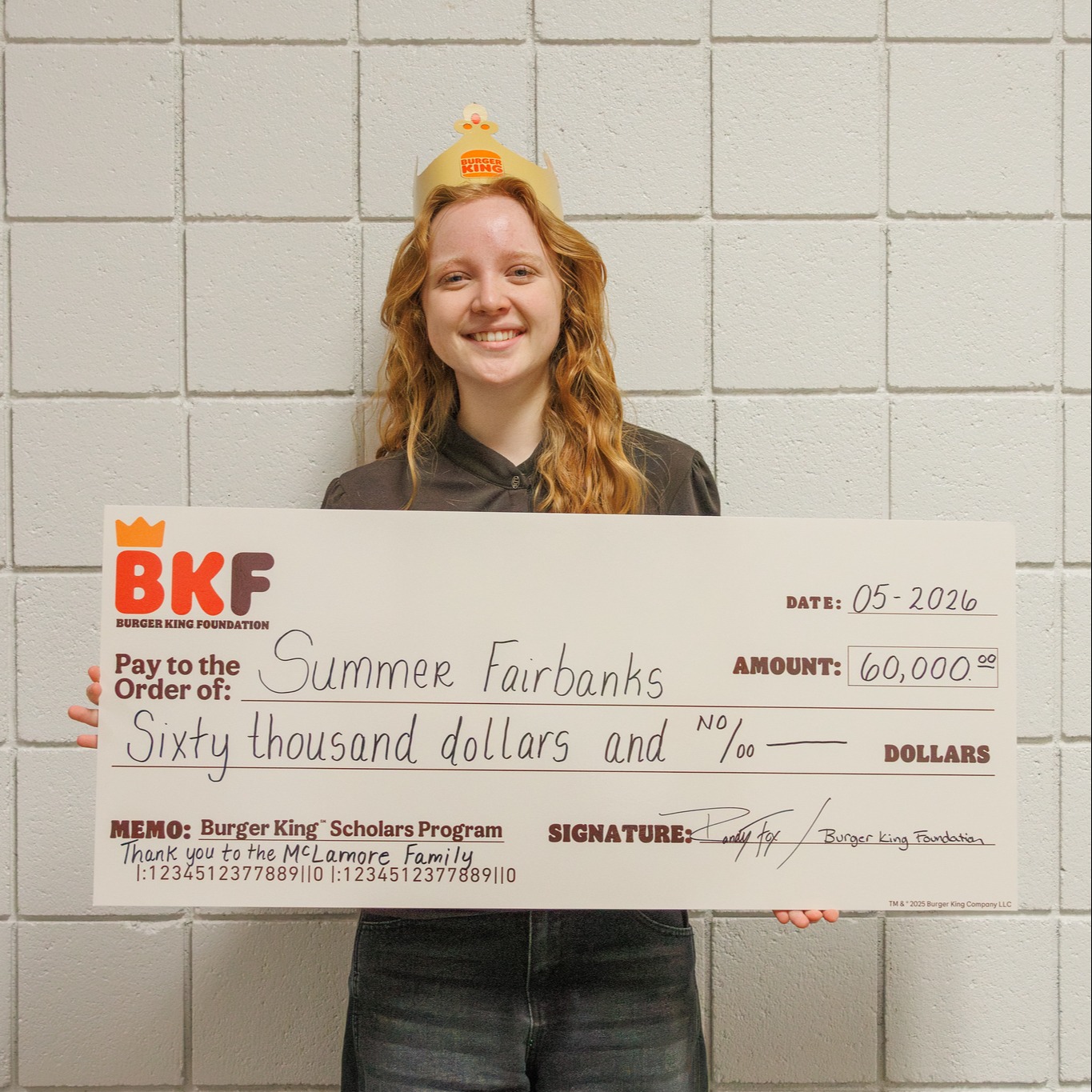 student holding large check from Burger King scholarhisps for $60,000 dollars