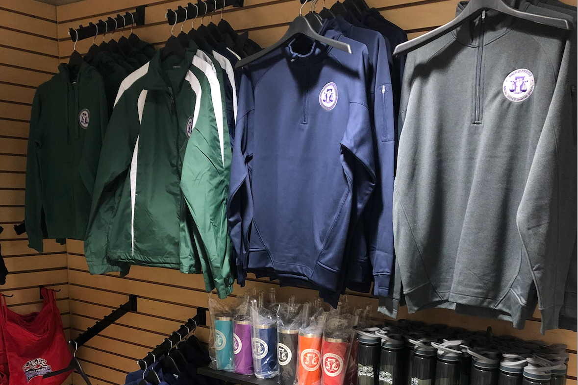 jackets on hangers and mugs with school logos