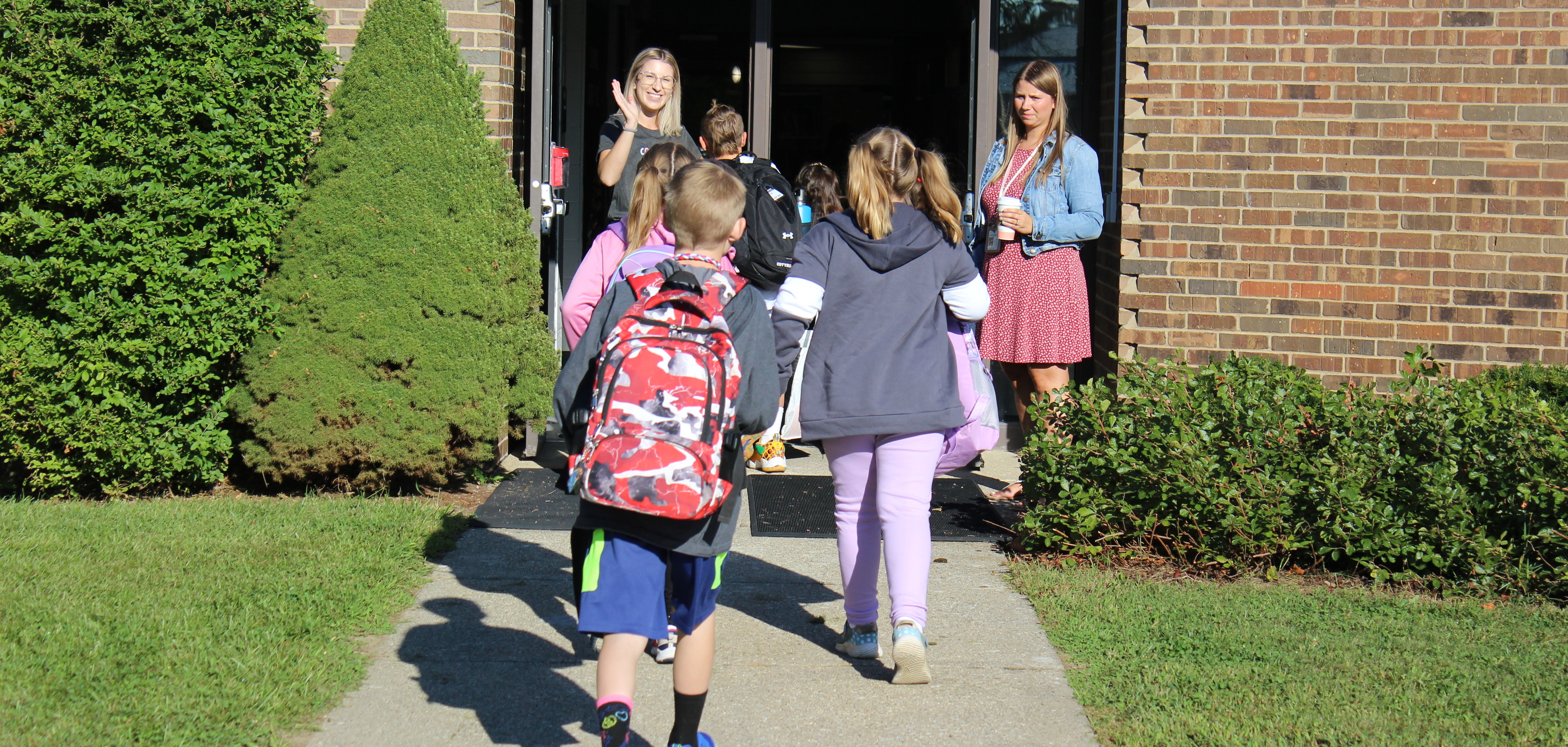 Teachers at Highland Elementary welcoming students on the first day of school