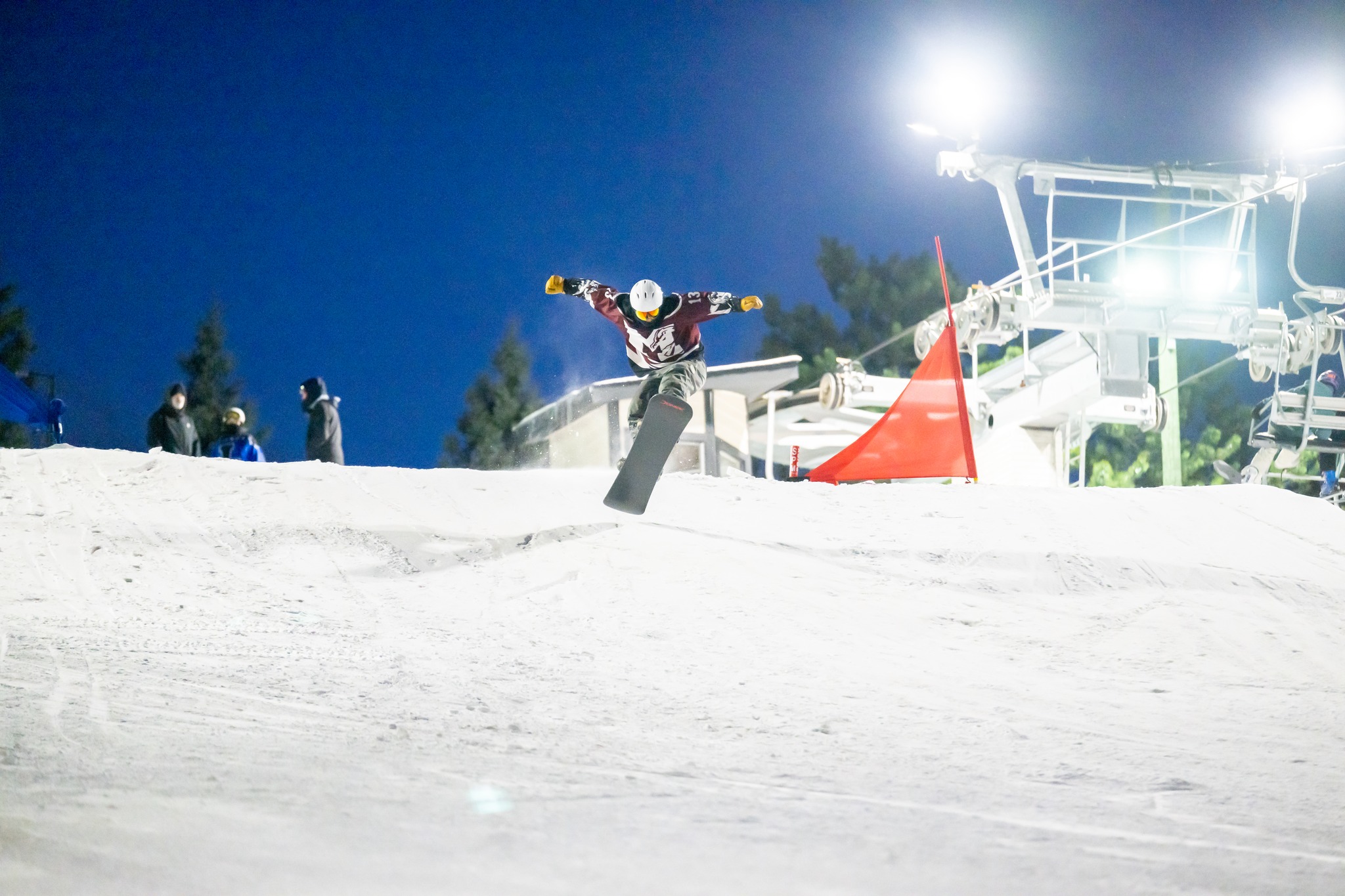 Milford snowboard lifting off a hill 