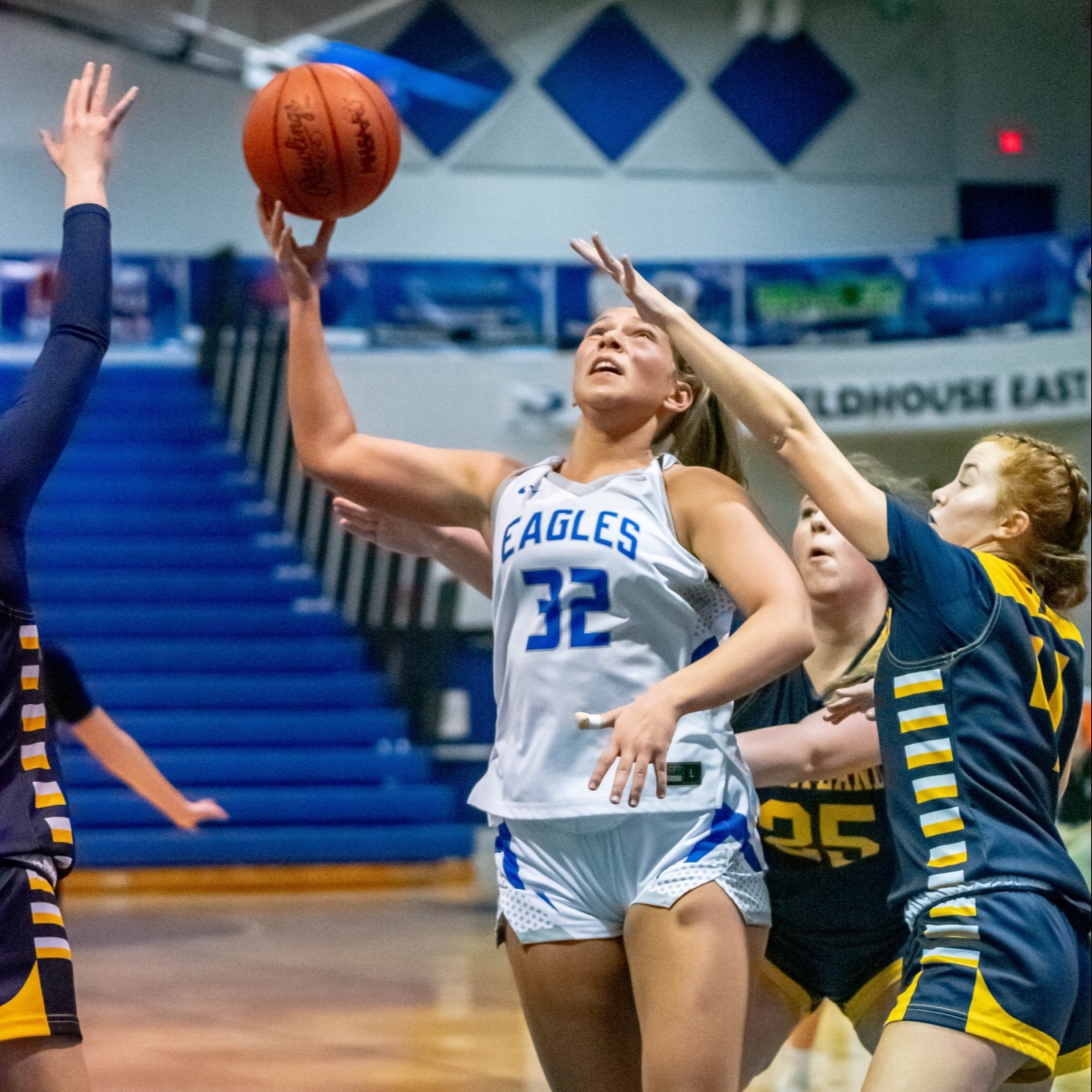 LHS girls basketball player shooting the ball under the rim
