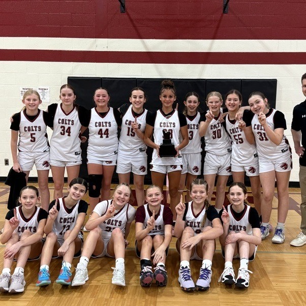 Muir girls basketball team celebrating a win on the court