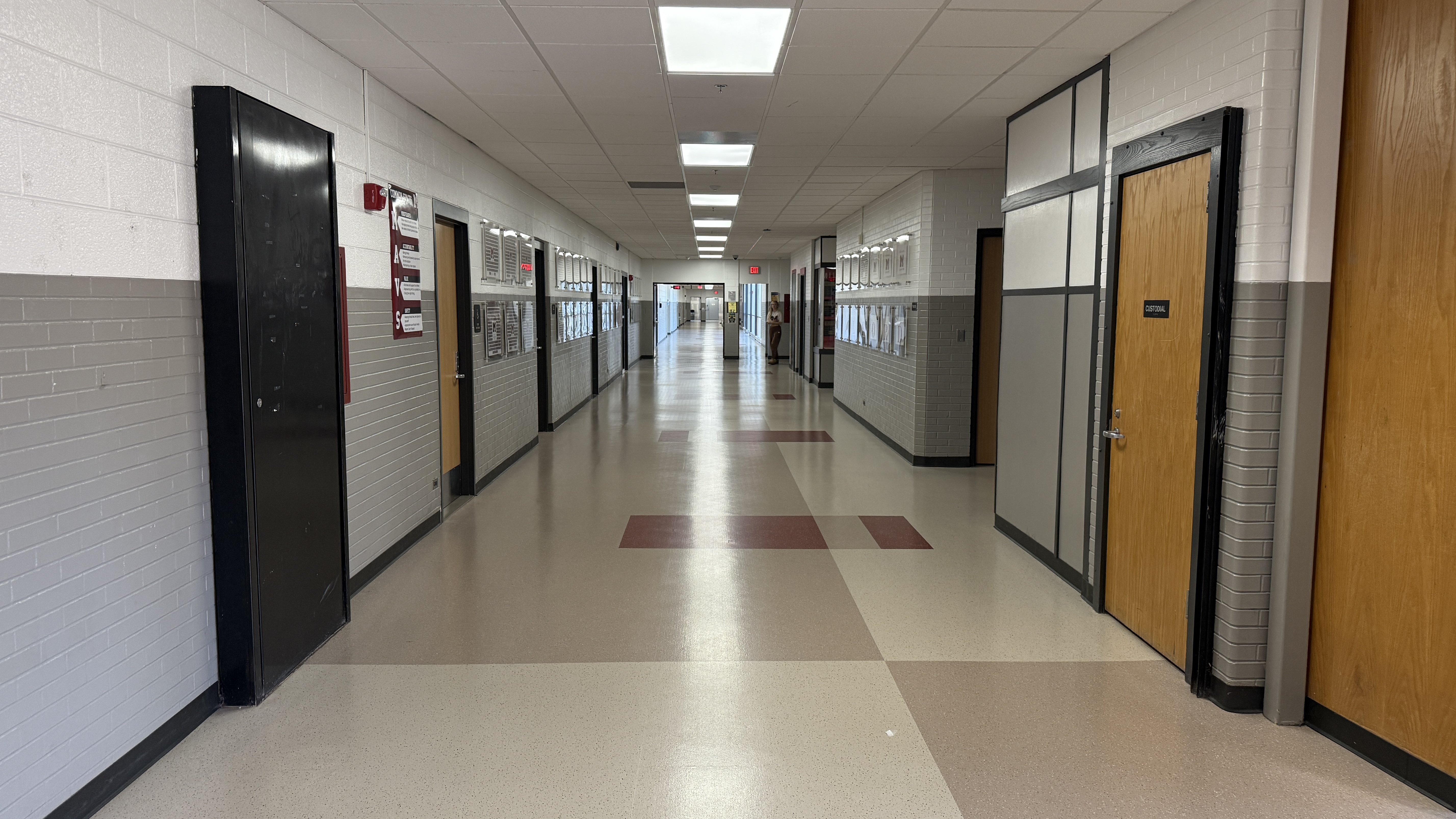 Empty hallway at Milford high. no students just lockers, doors and walls.
