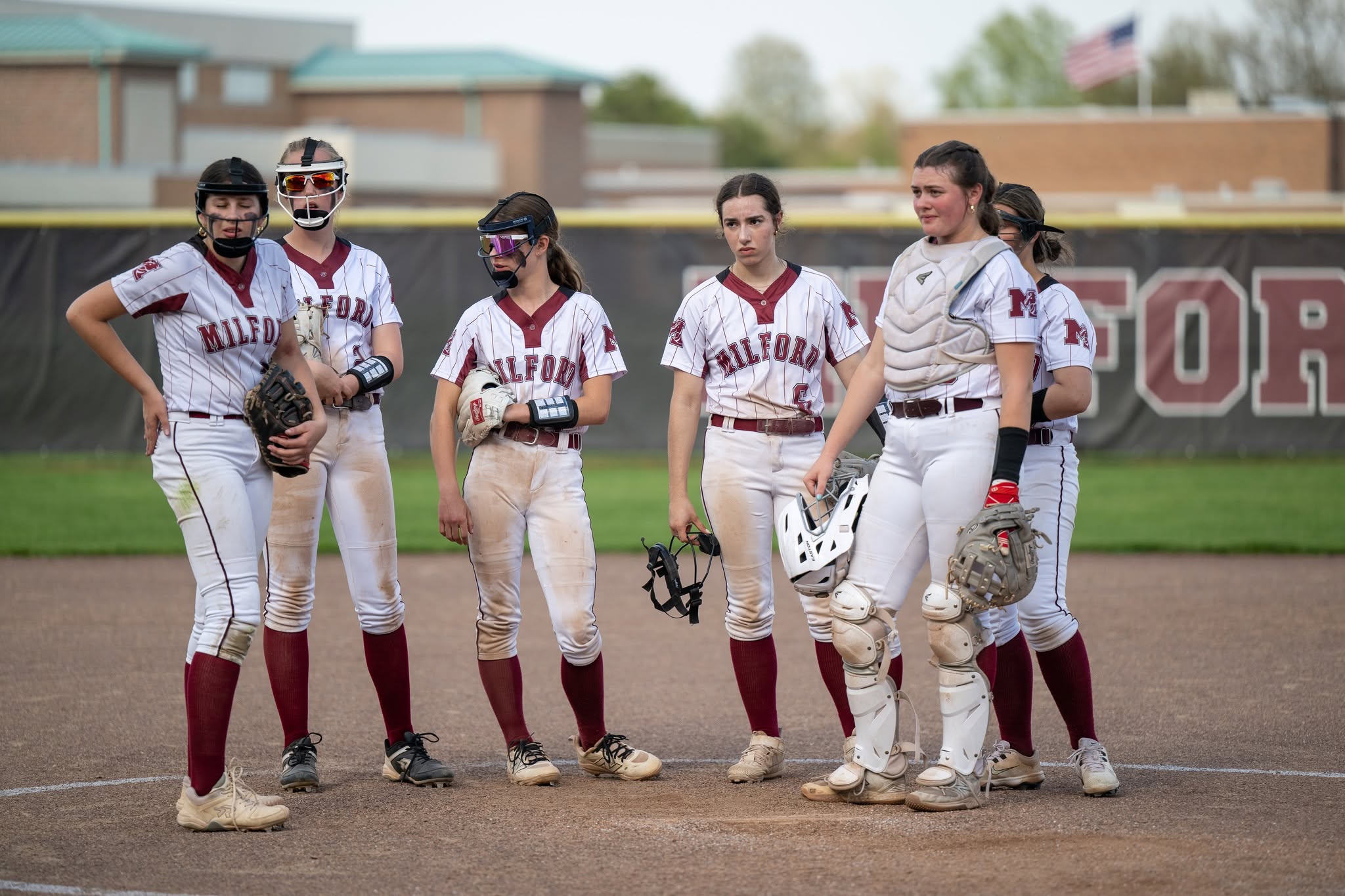 girl softball players standing on the field