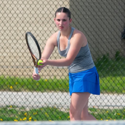 Girl ready to serve ball in tennis