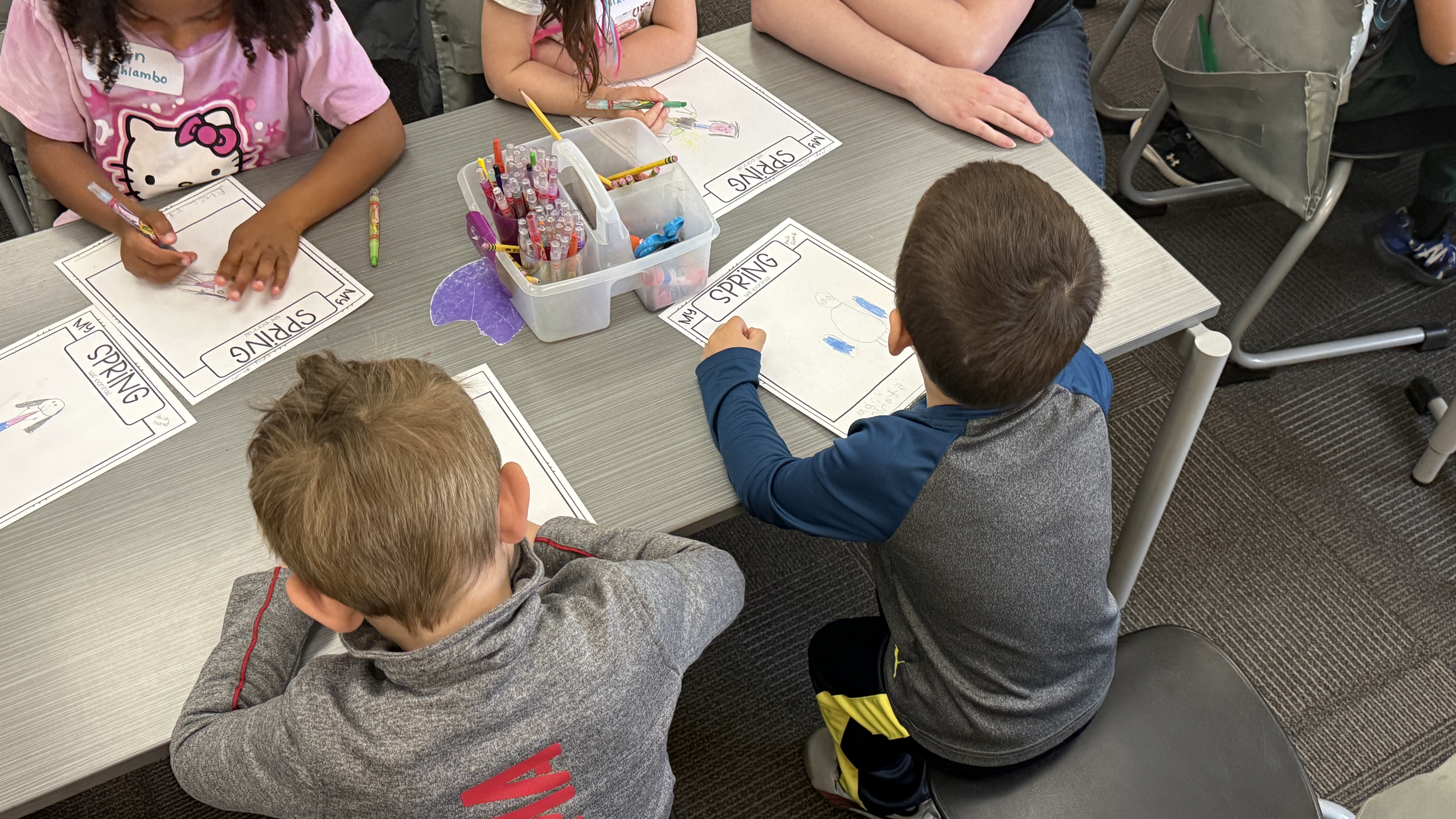 overhead photo of students sitting at classroom table