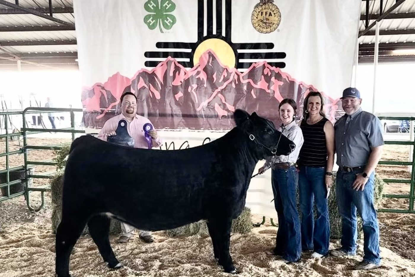Cady McVaugh standing next to her Grand Champion heifer.