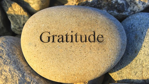 The word gratitude written on a rock
