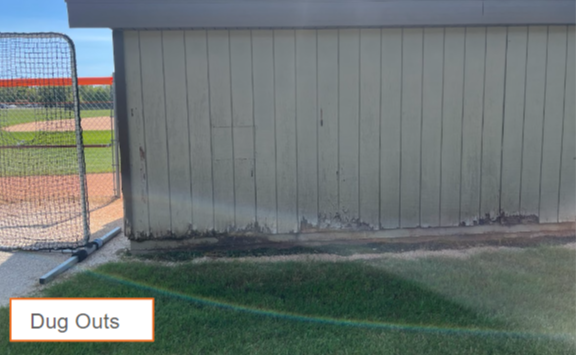 edge of the dugouts with siding peeling away