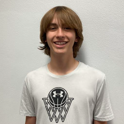 Smiling junior high boy with brown hair and a white/black under armour t-shirt