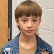 young man with a light brown hair wearing a tan t-shirt under a jean jacket