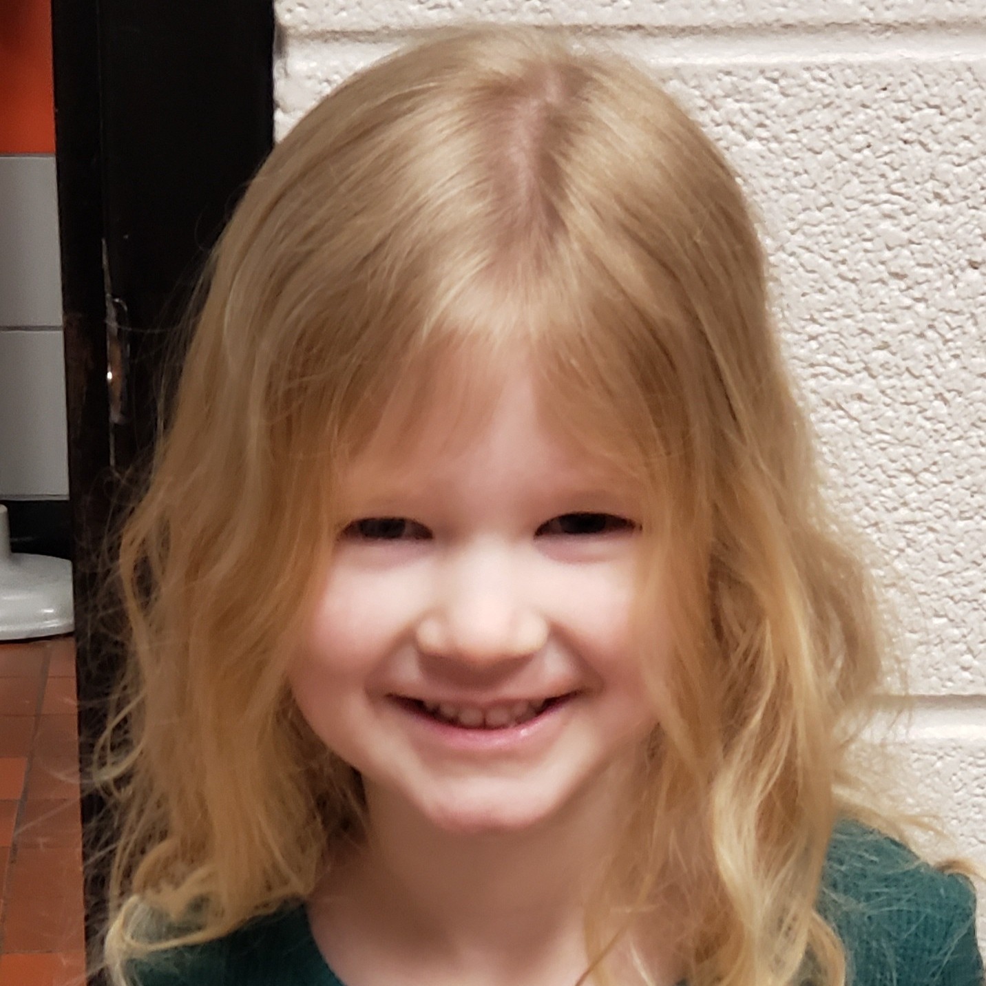 smiling little girl with strawberry blonde hair 