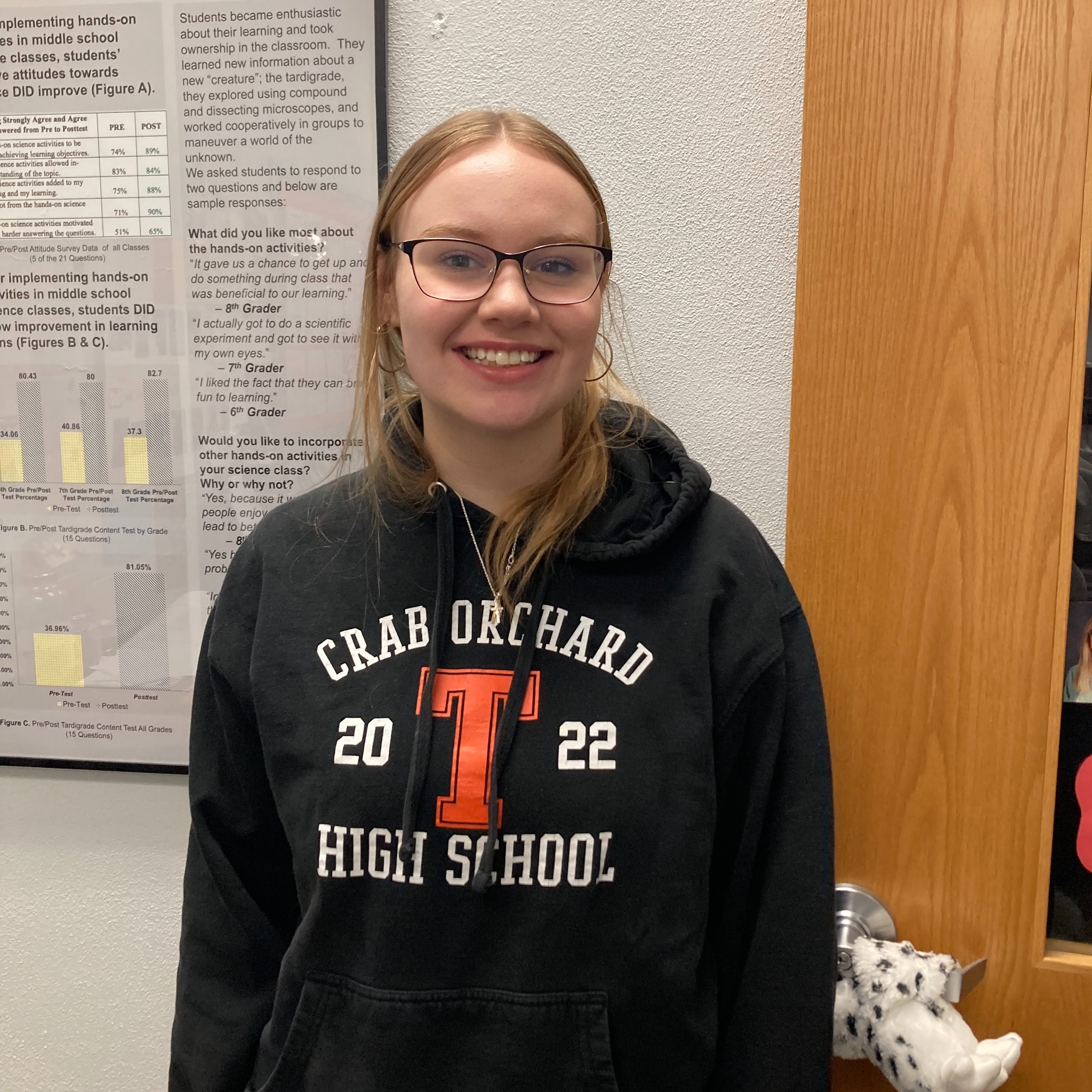 high school female wearing a black trojan hoodie