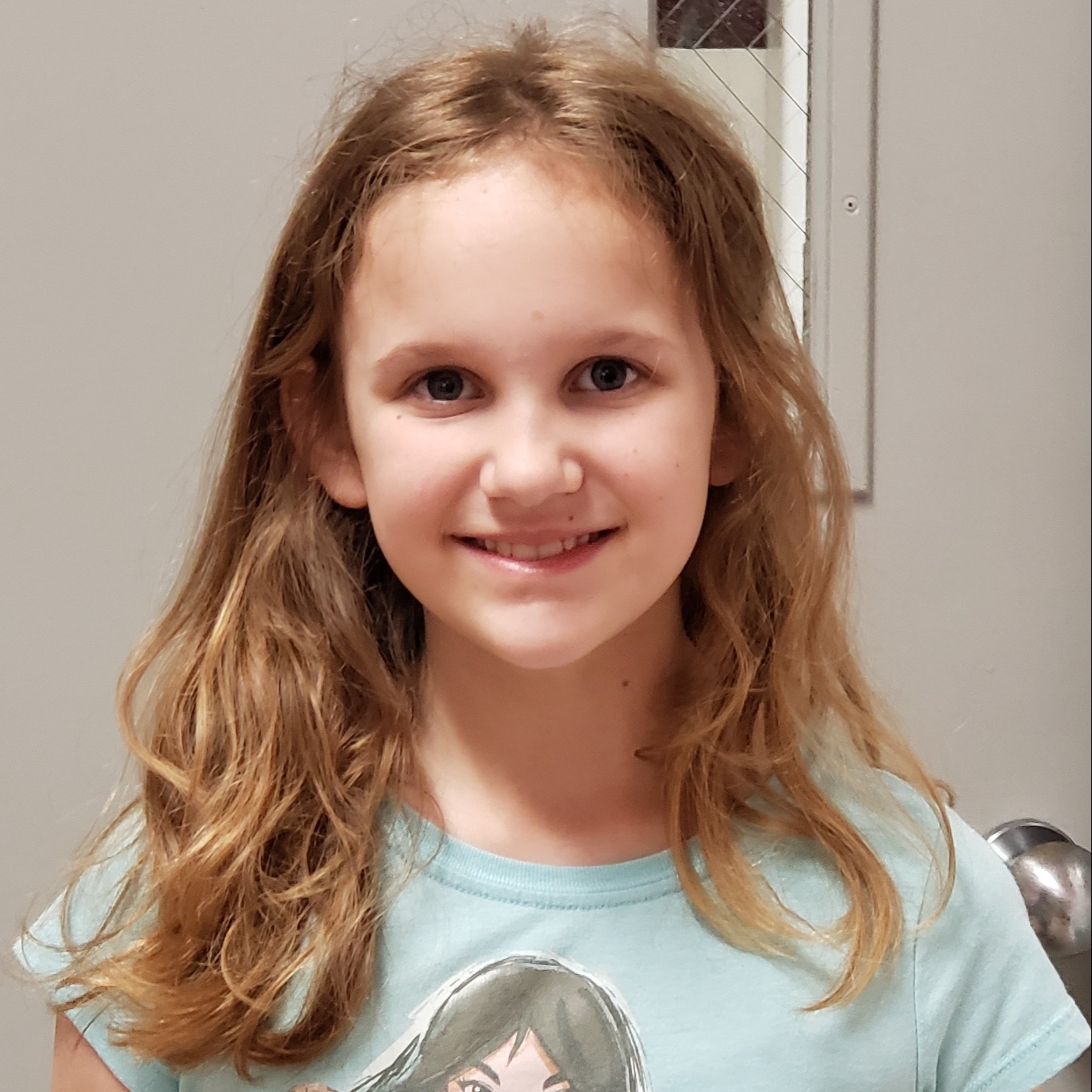 girl with blonde hair wearing a mint t-shirt