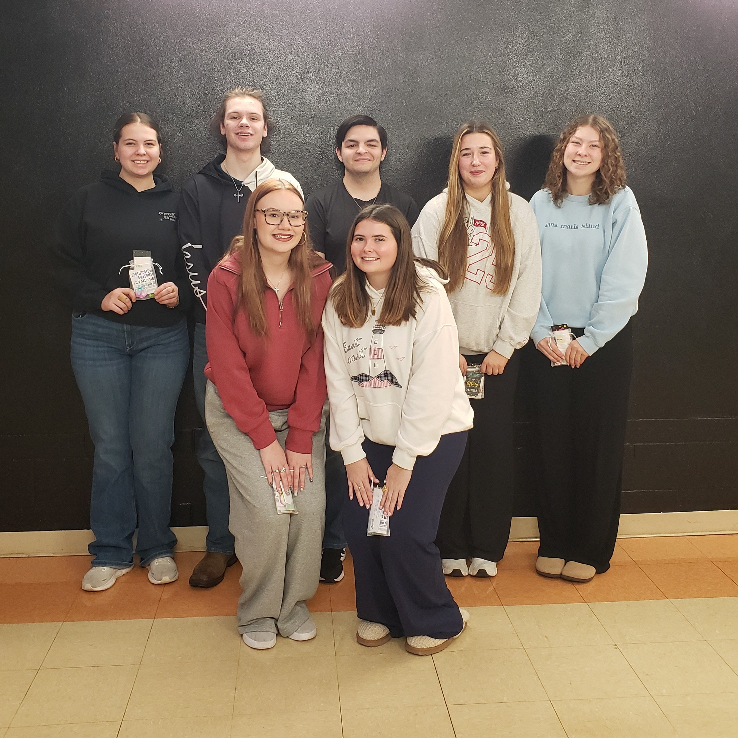 2 male & 5 female high school students wearing jeans & sweatshirts