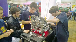 L to R: Justin, Max, Ben and Charles prep the robot for competition prior to the start of the East Super Regionals.