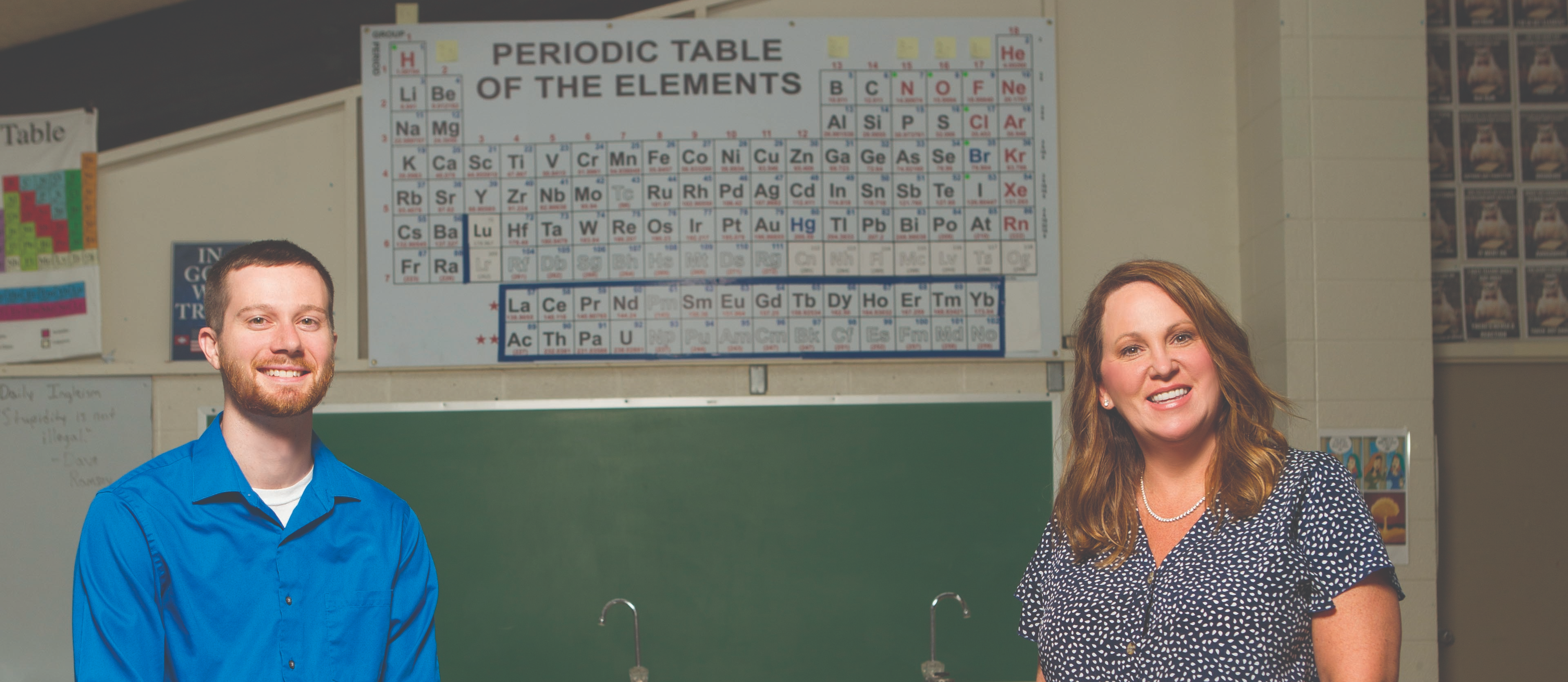 Two teachers posing in a science classroom