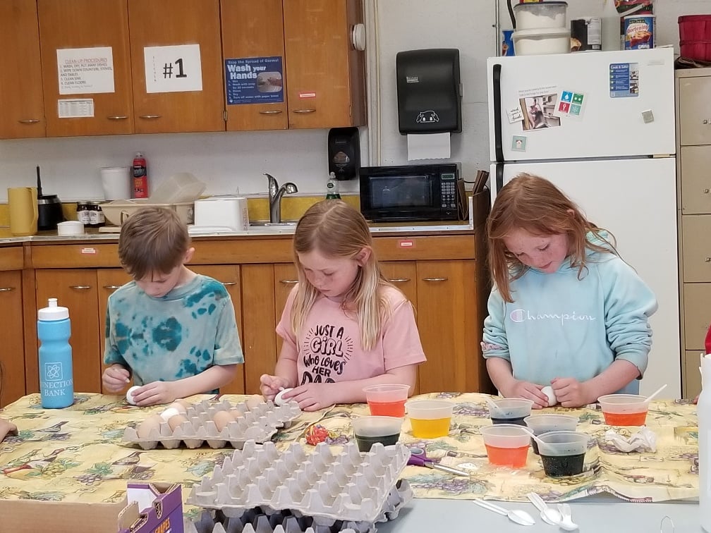 Students decorating eggs together