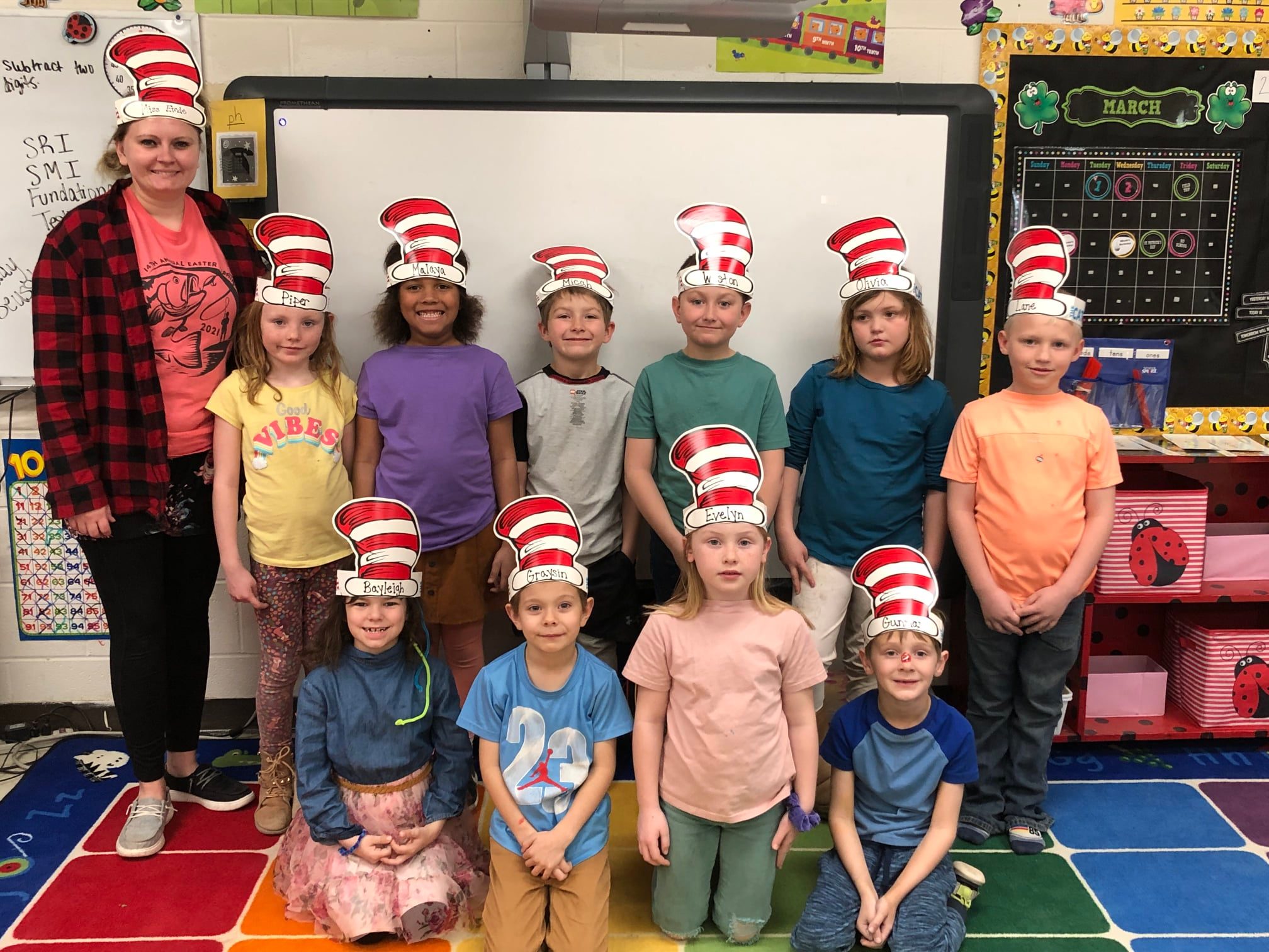 students pose with cat-in-the-hat hats on in classroom