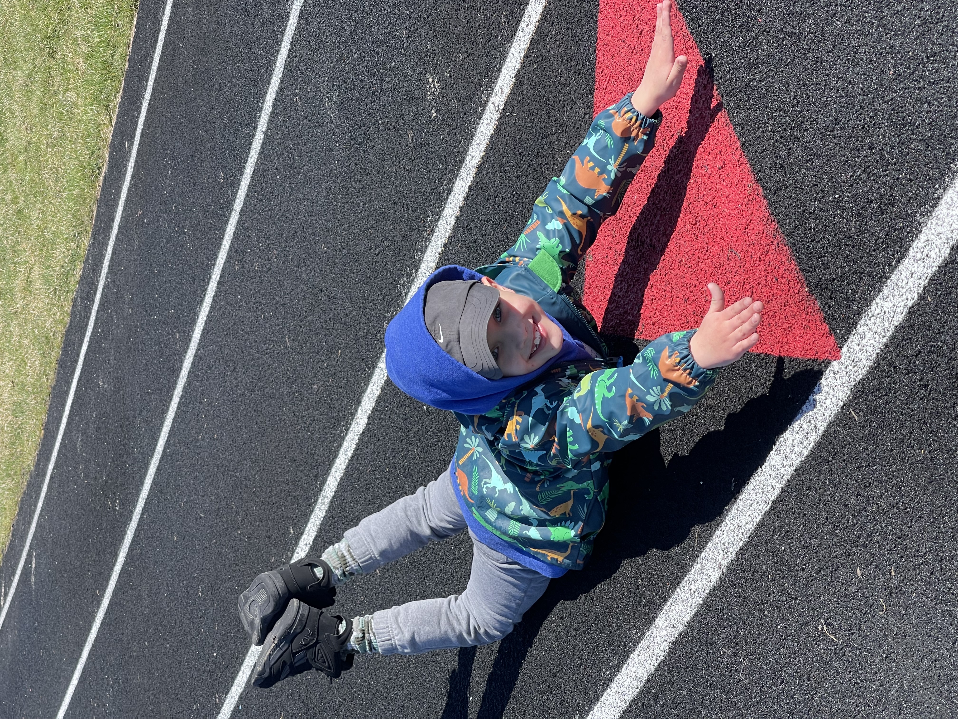 Kid on a track doing a superman exercise