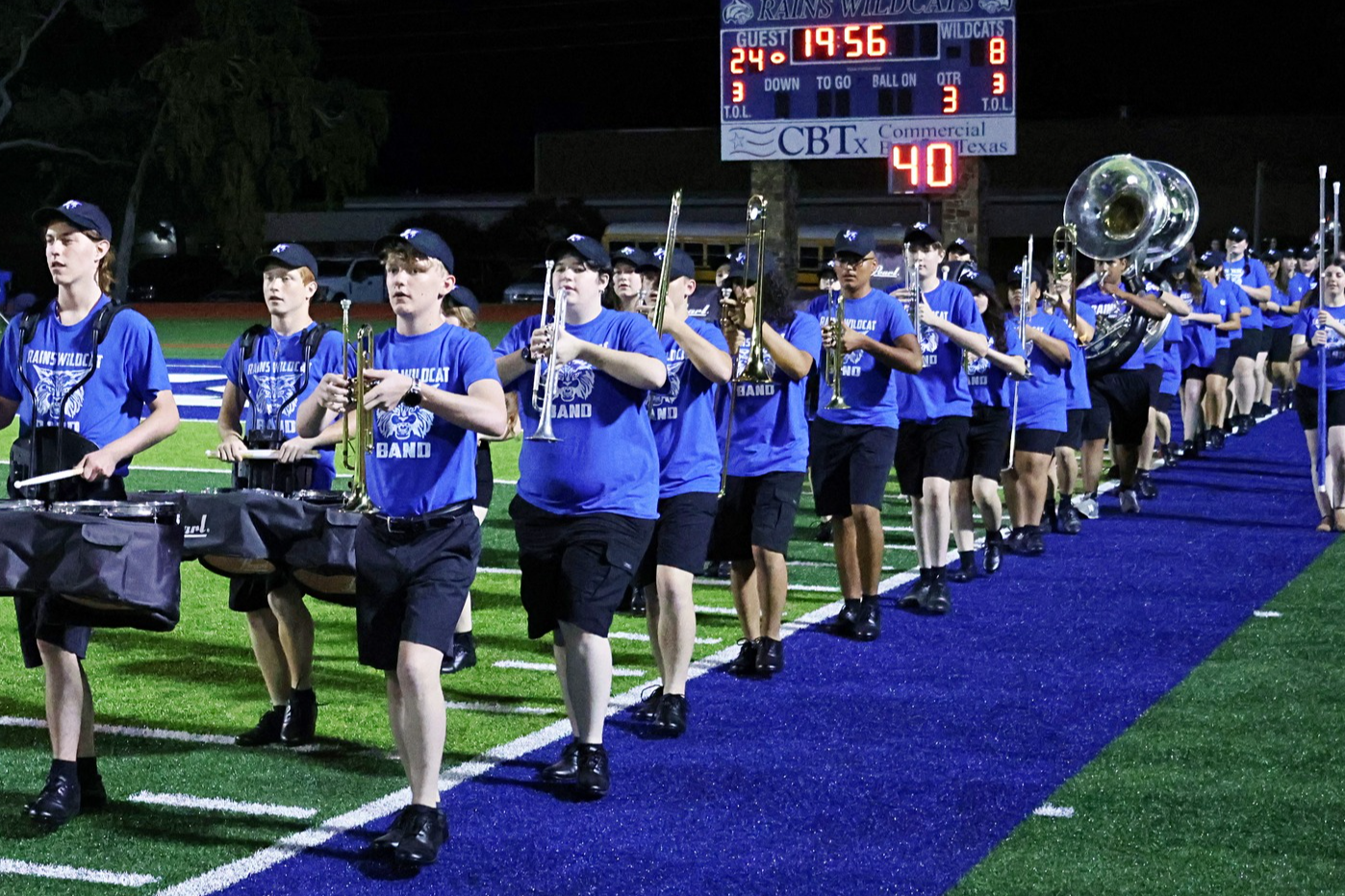 marching band performers and theater students on stage