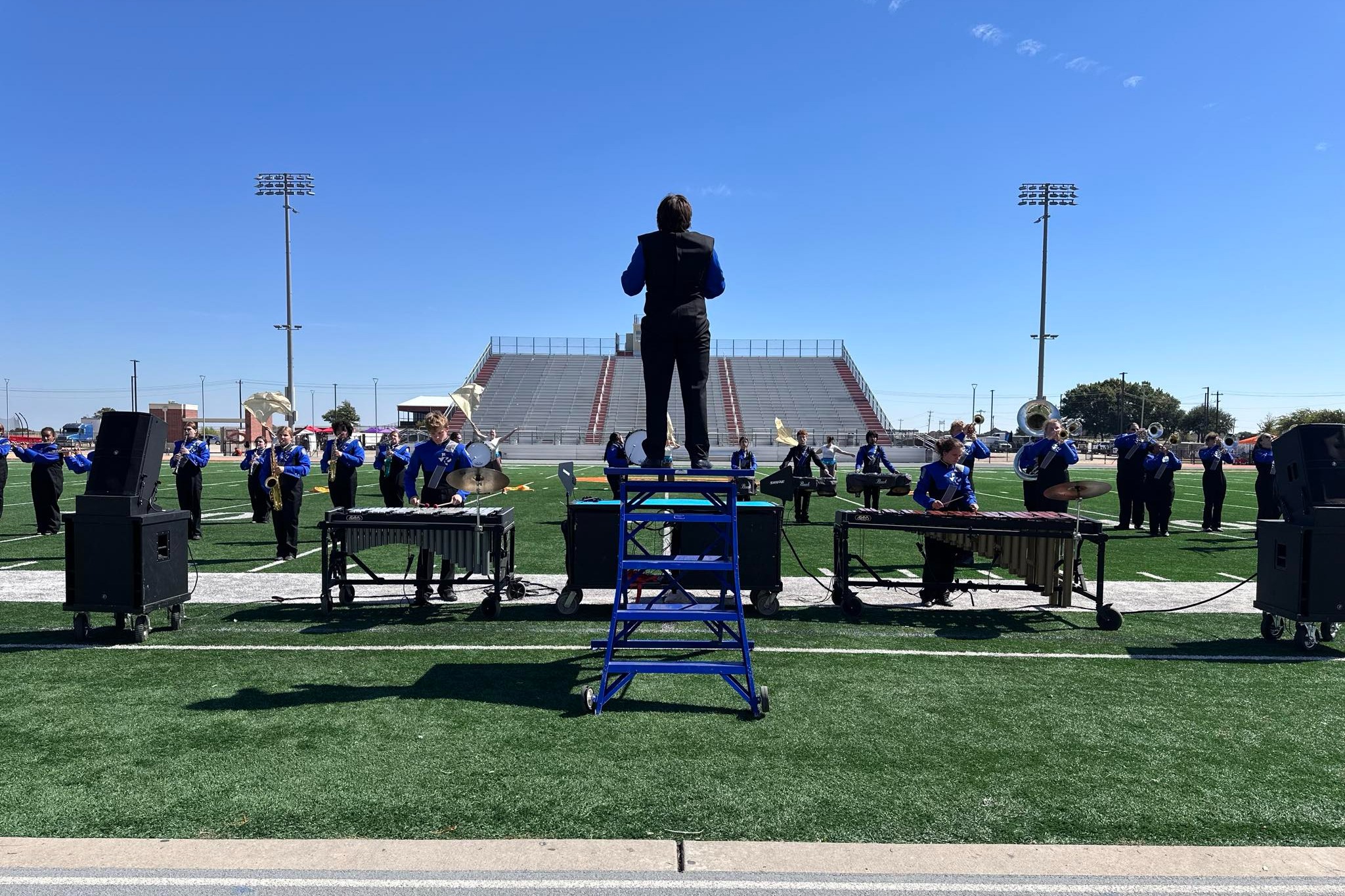 marching band performers and theater students on stage