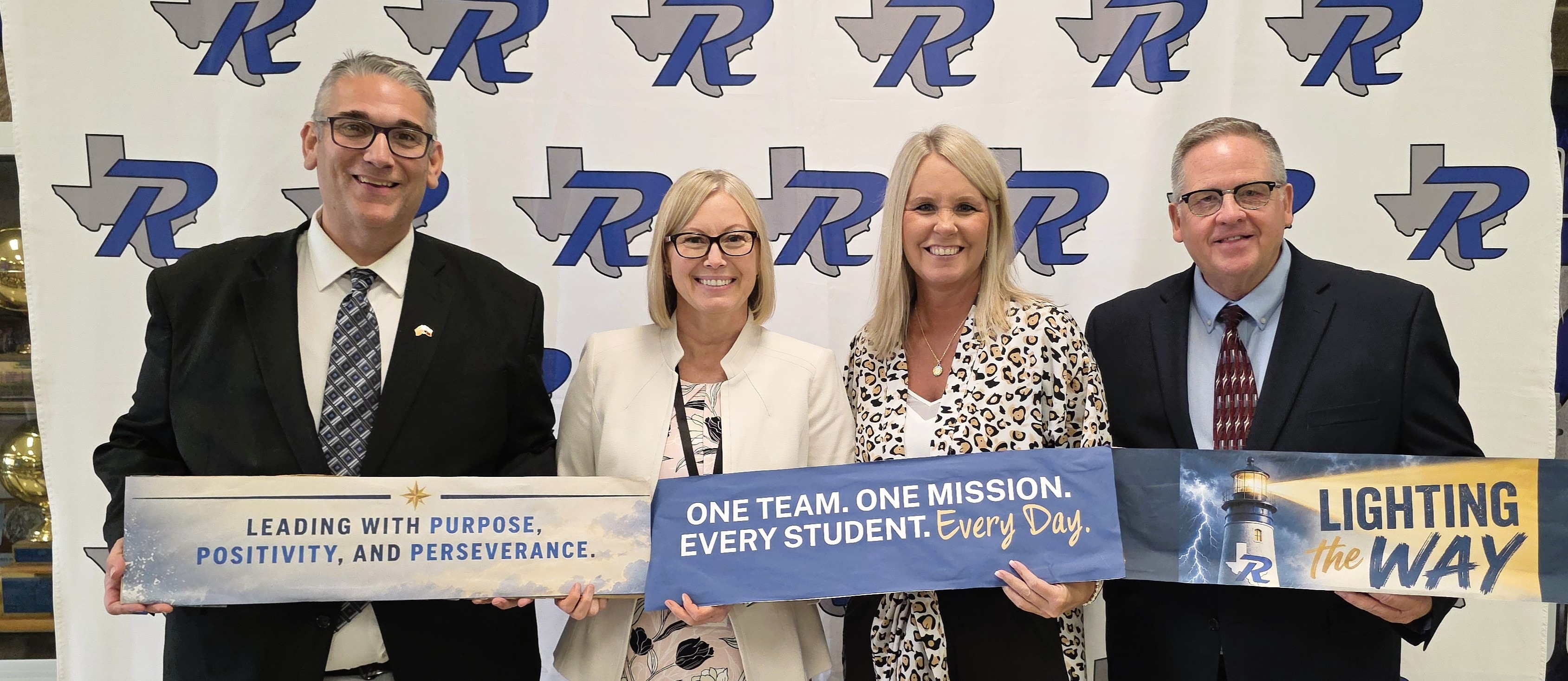 Rains administrators posing together for a group picture. 