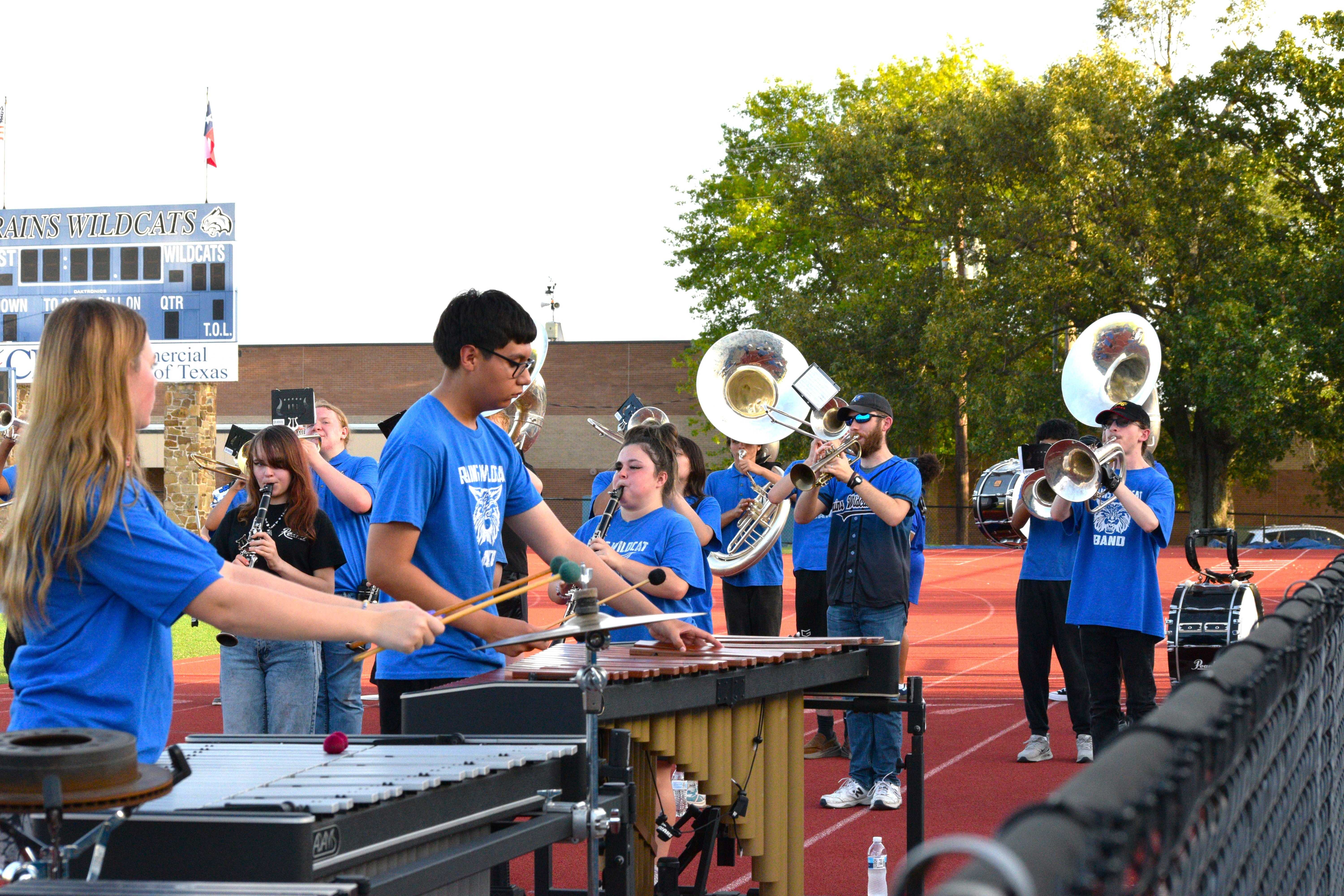 marching band performers and theater students on stage