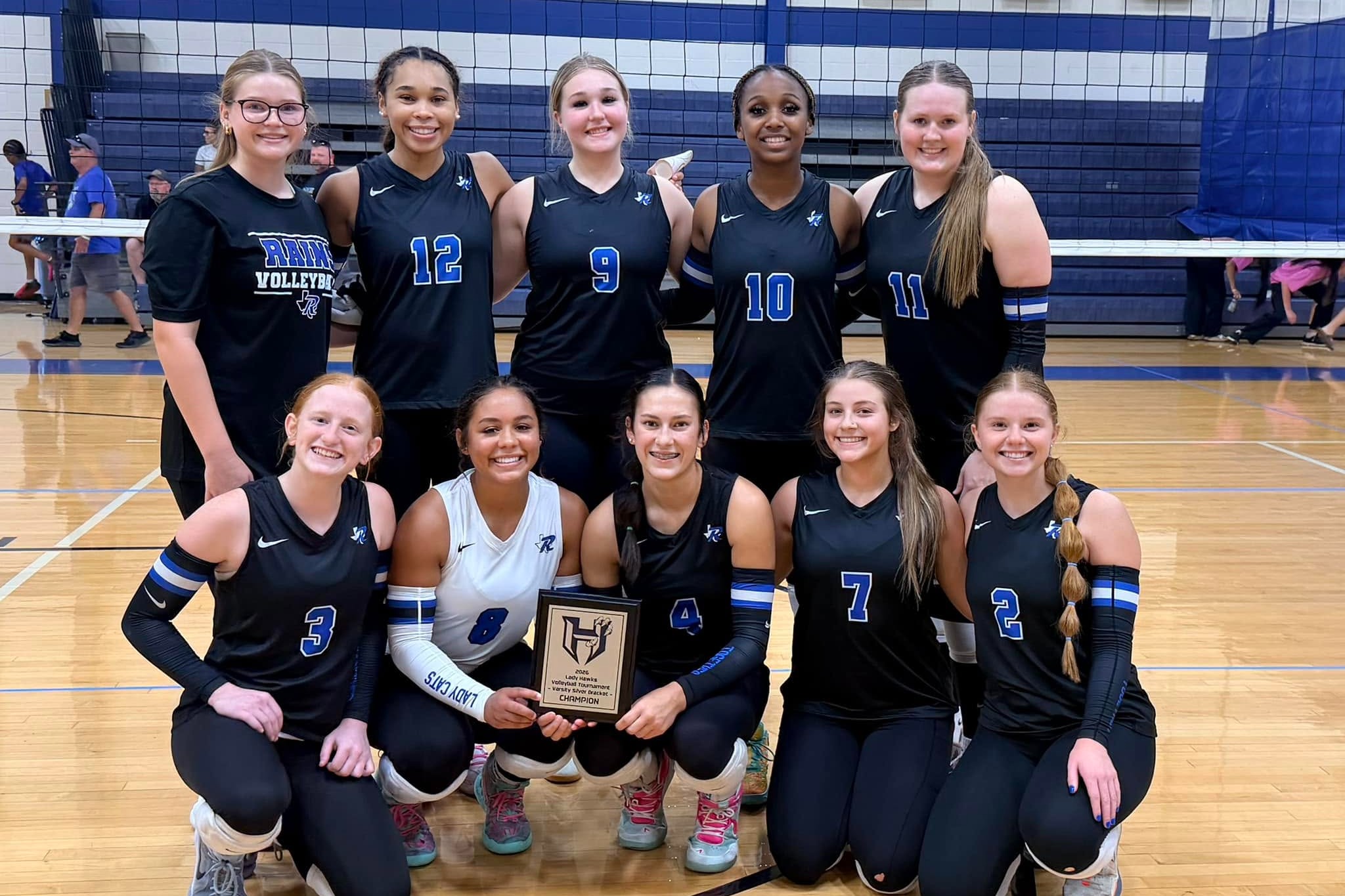 volleyball team with their championship plaque 