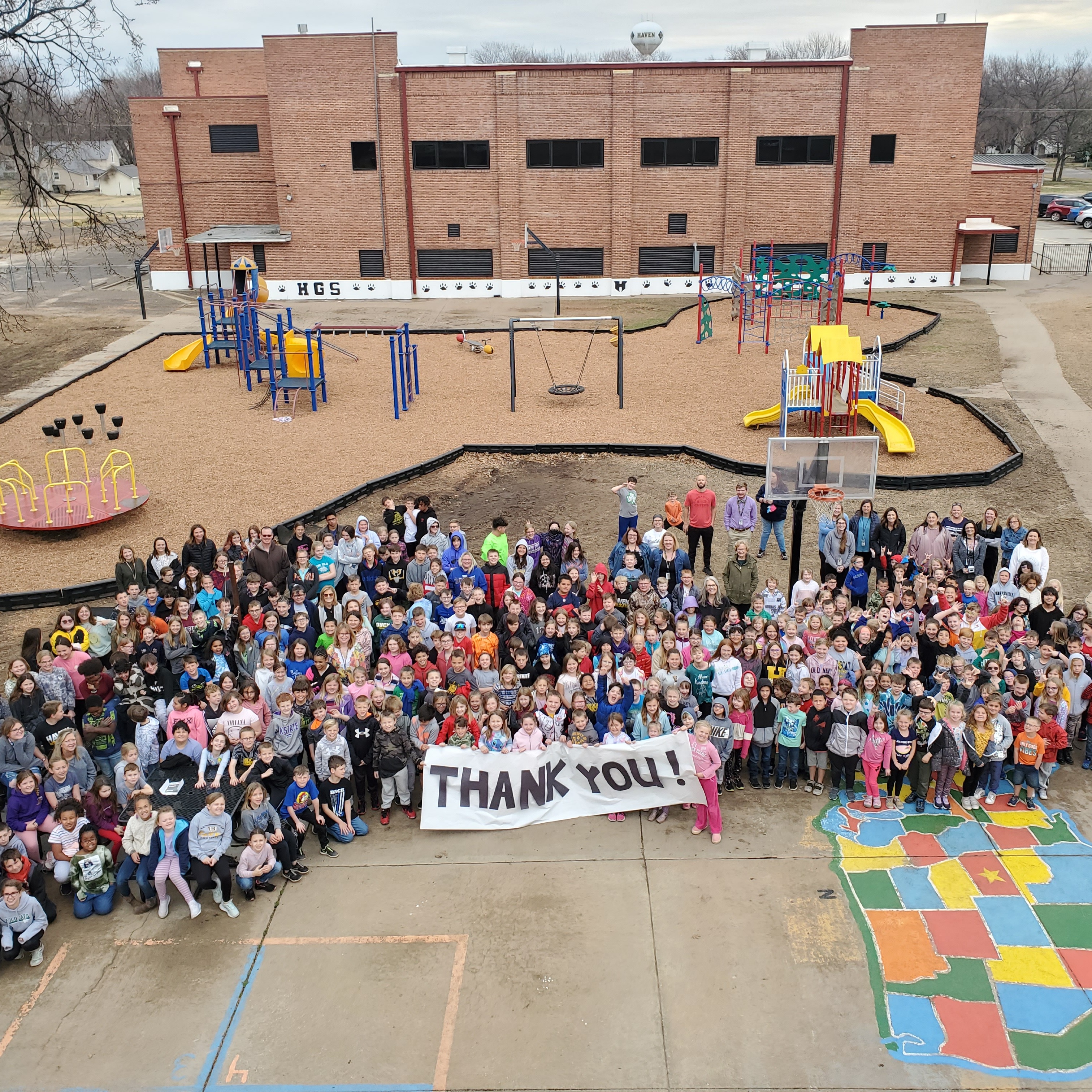 Staff and Students With Sign that says Thank you