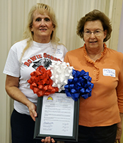 Two Bowie women holding up a Chamber of Commerce letter