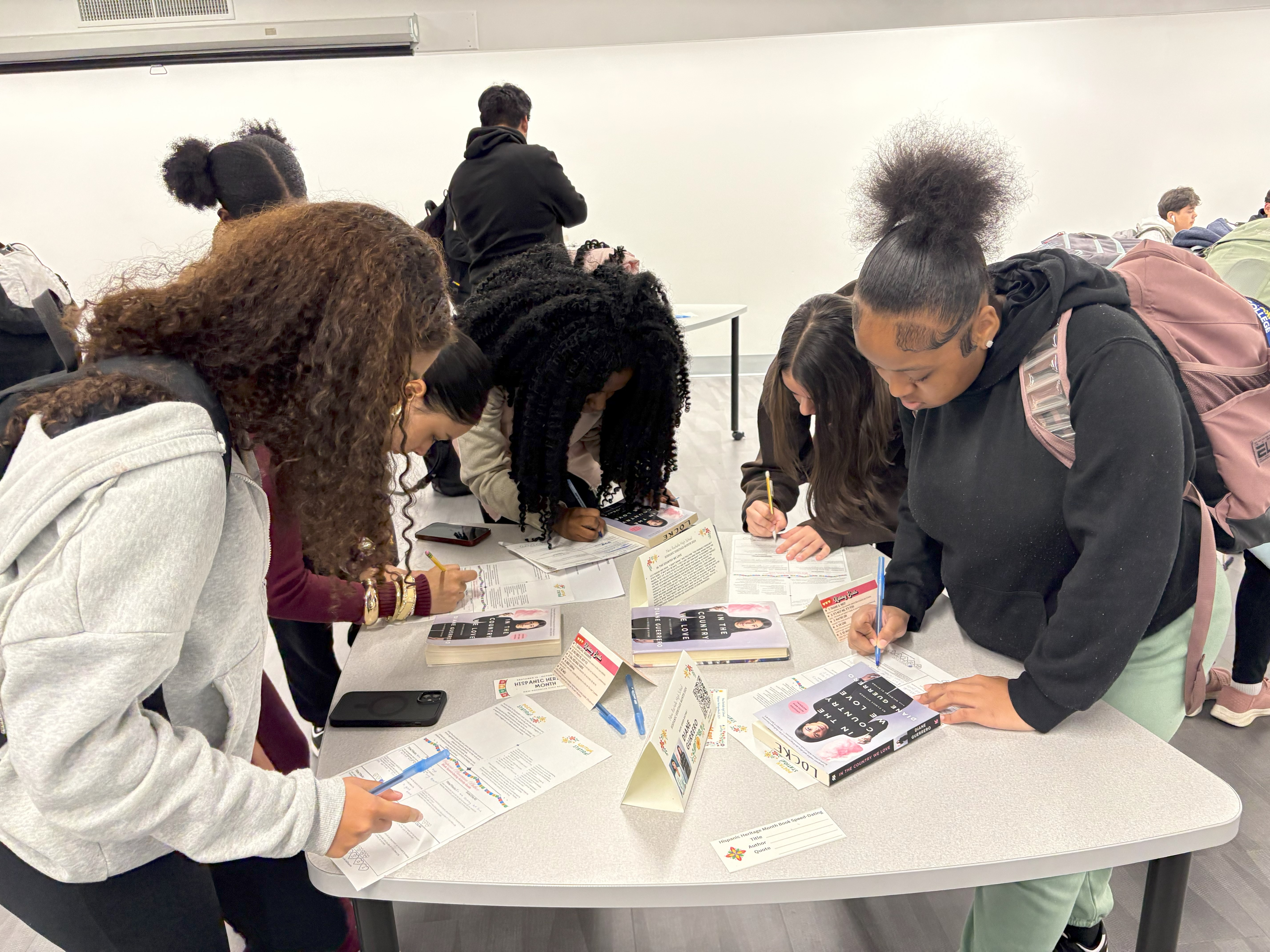 Students work at a book tasting table