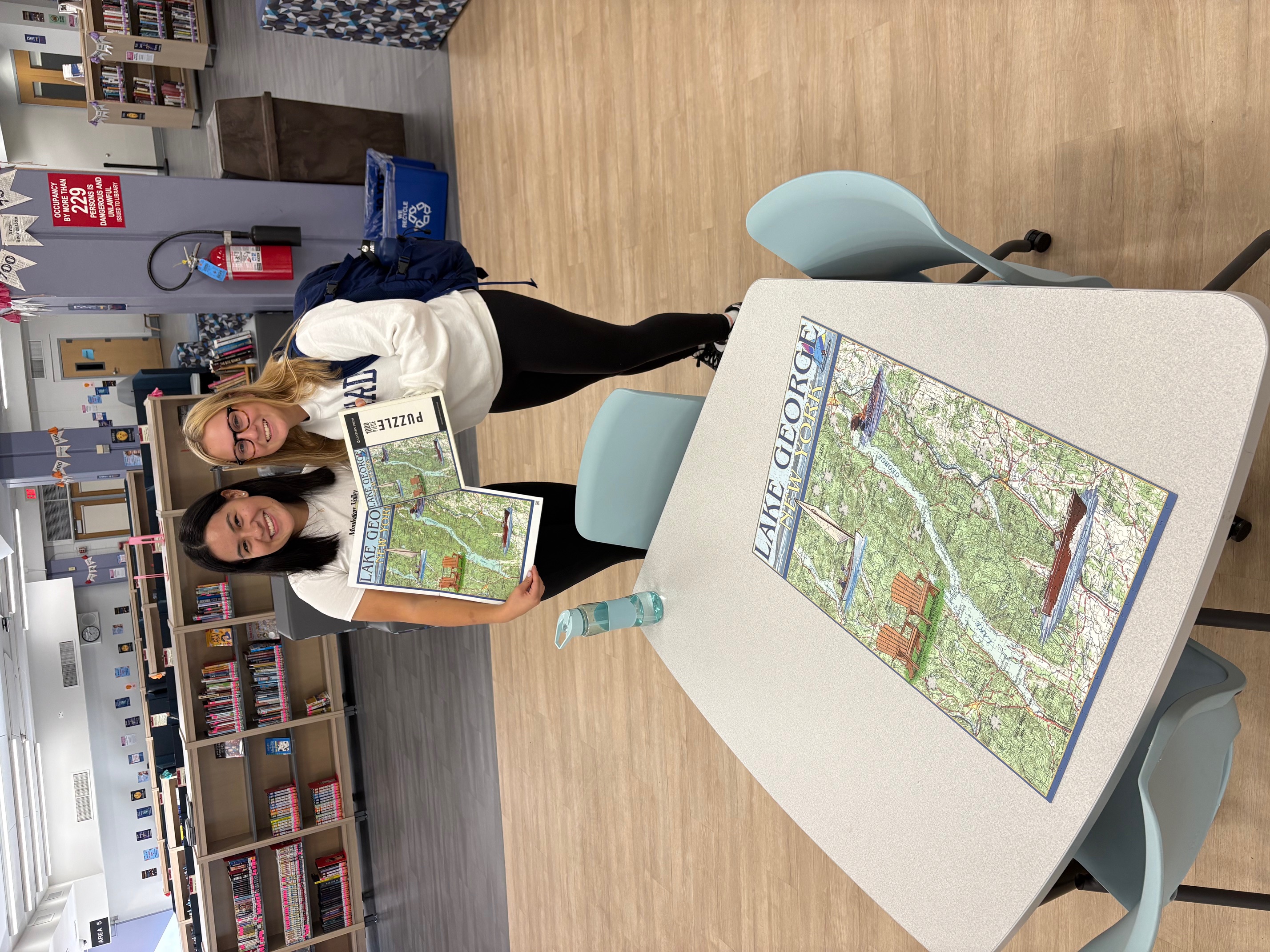 Students standing with completed puzzle