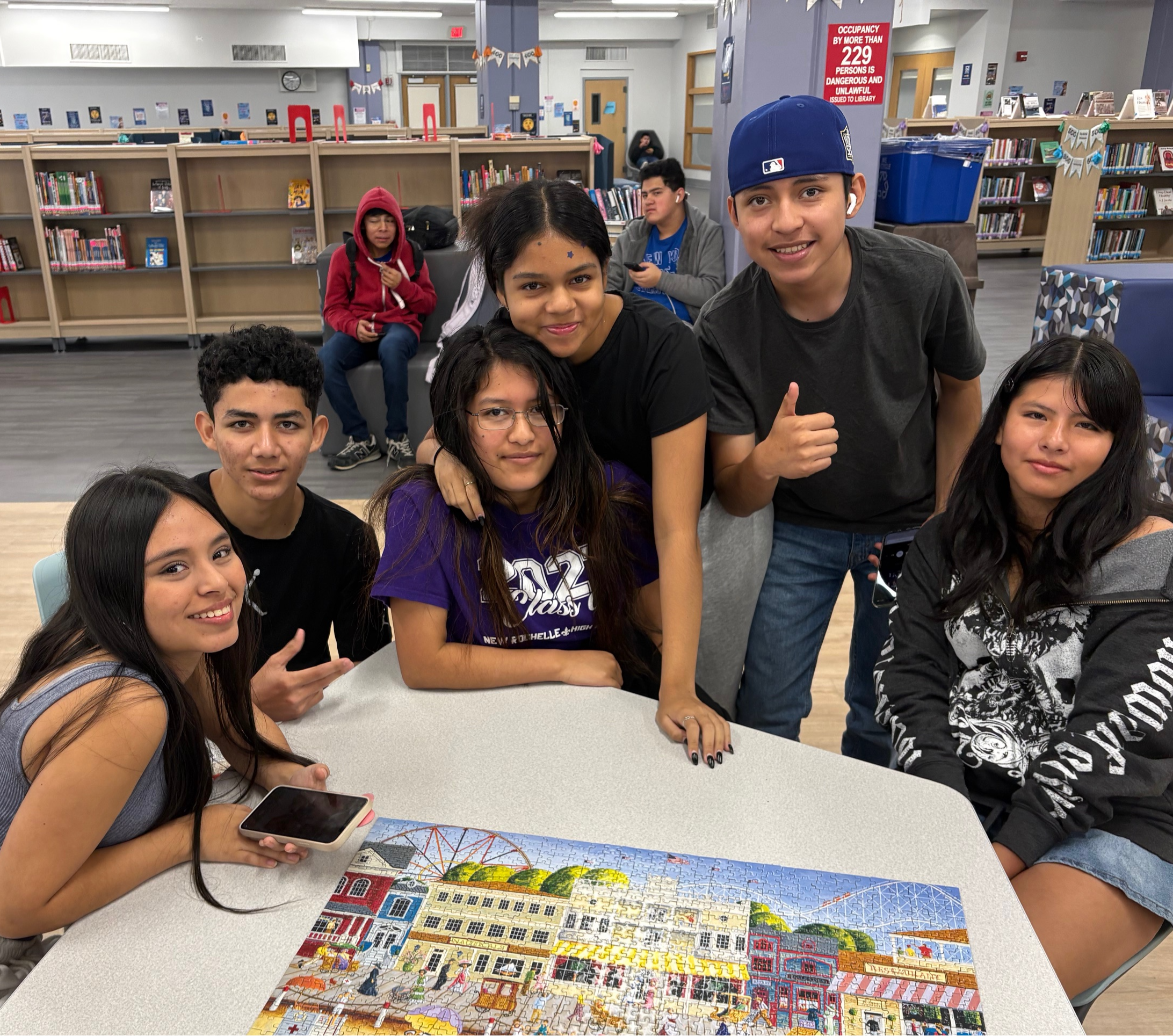 Students standing with completed Puzzle