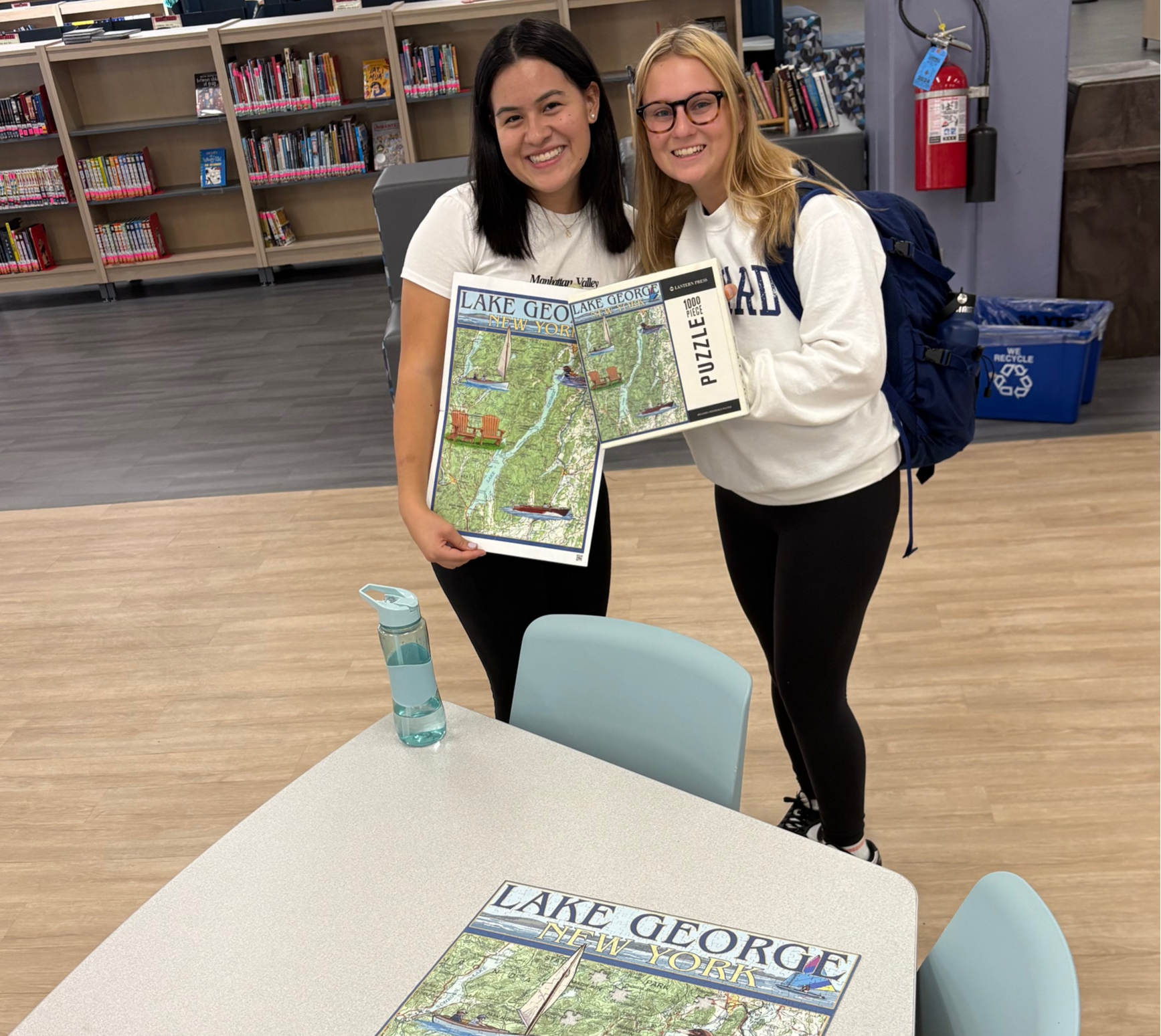 Students standing with completed puzzle