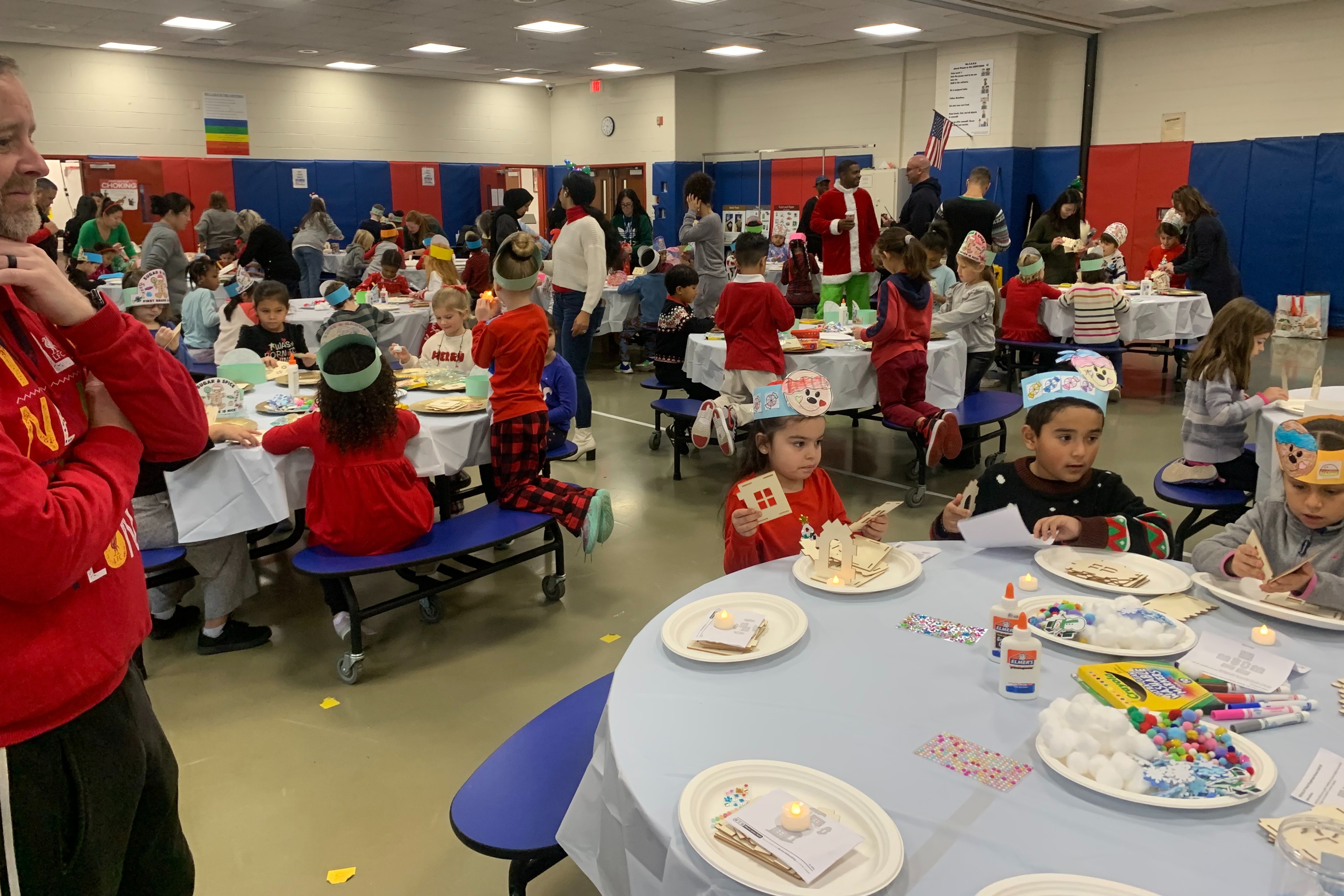 Students assemble gingerbread house crafts