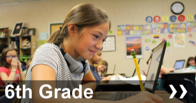 6th Grade student in front of laptop with pencil in her hand