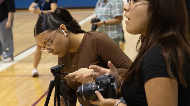 two students working with cameras