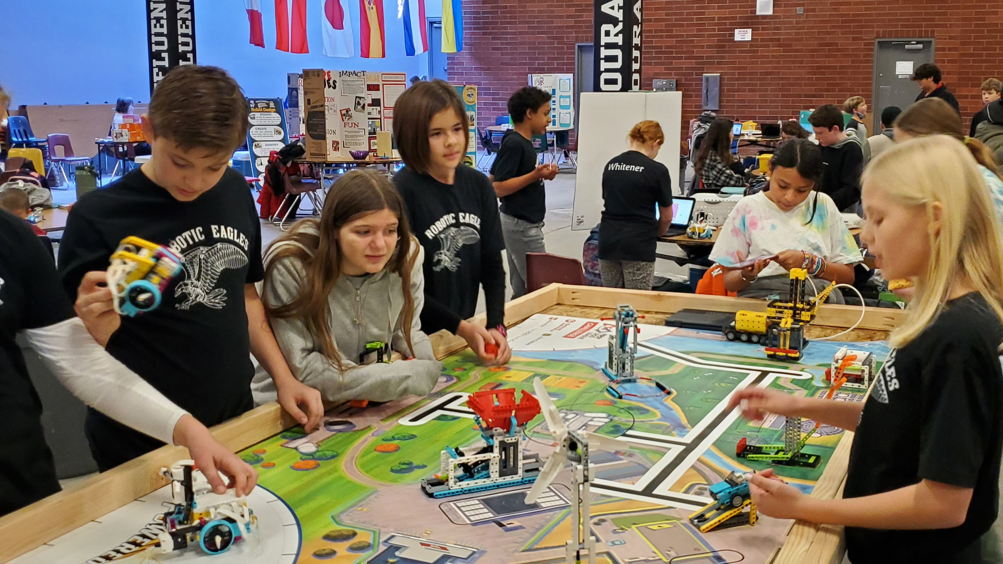 students working around a  sim town table