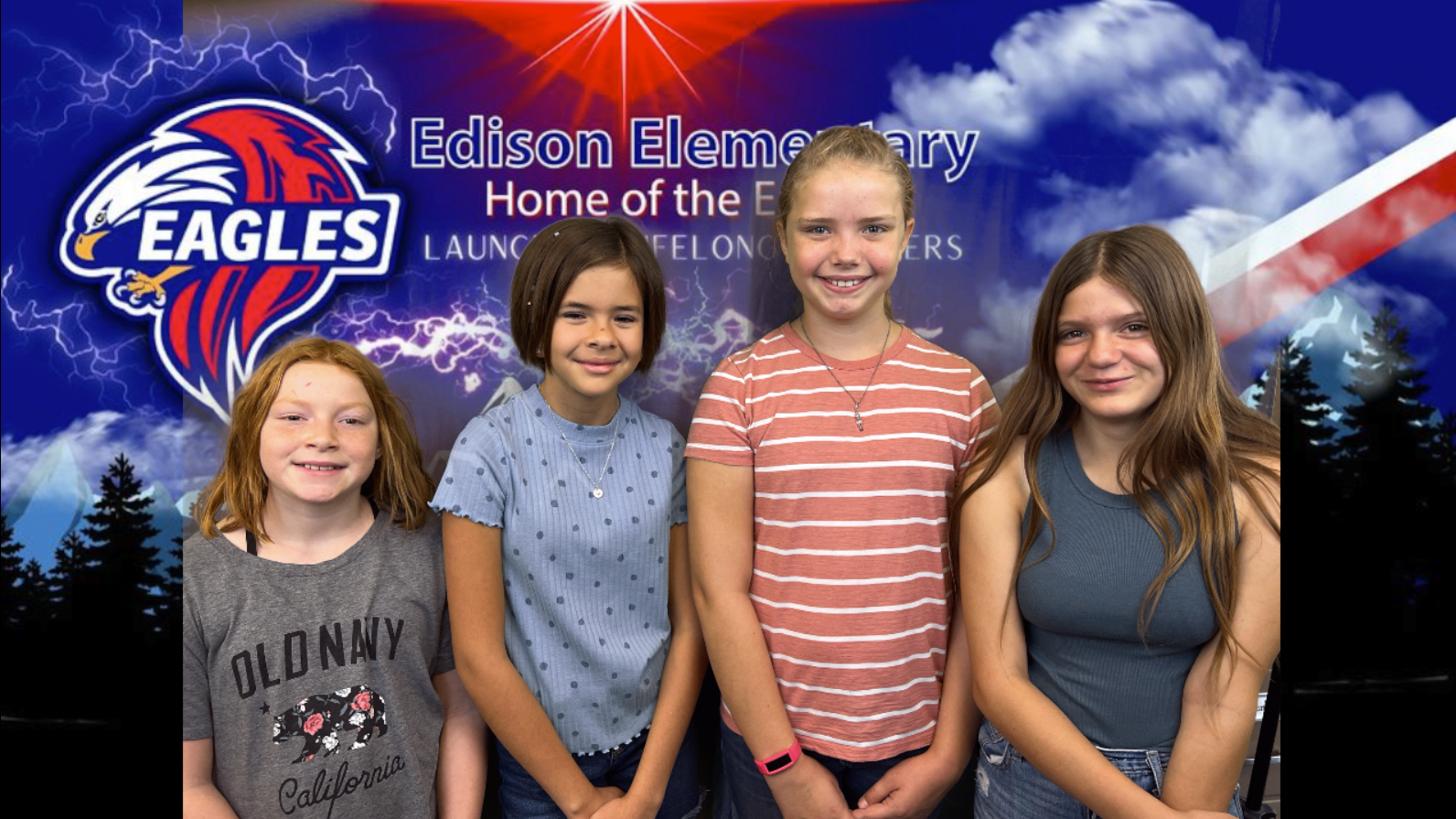 four students standing in front of an Edison school banner