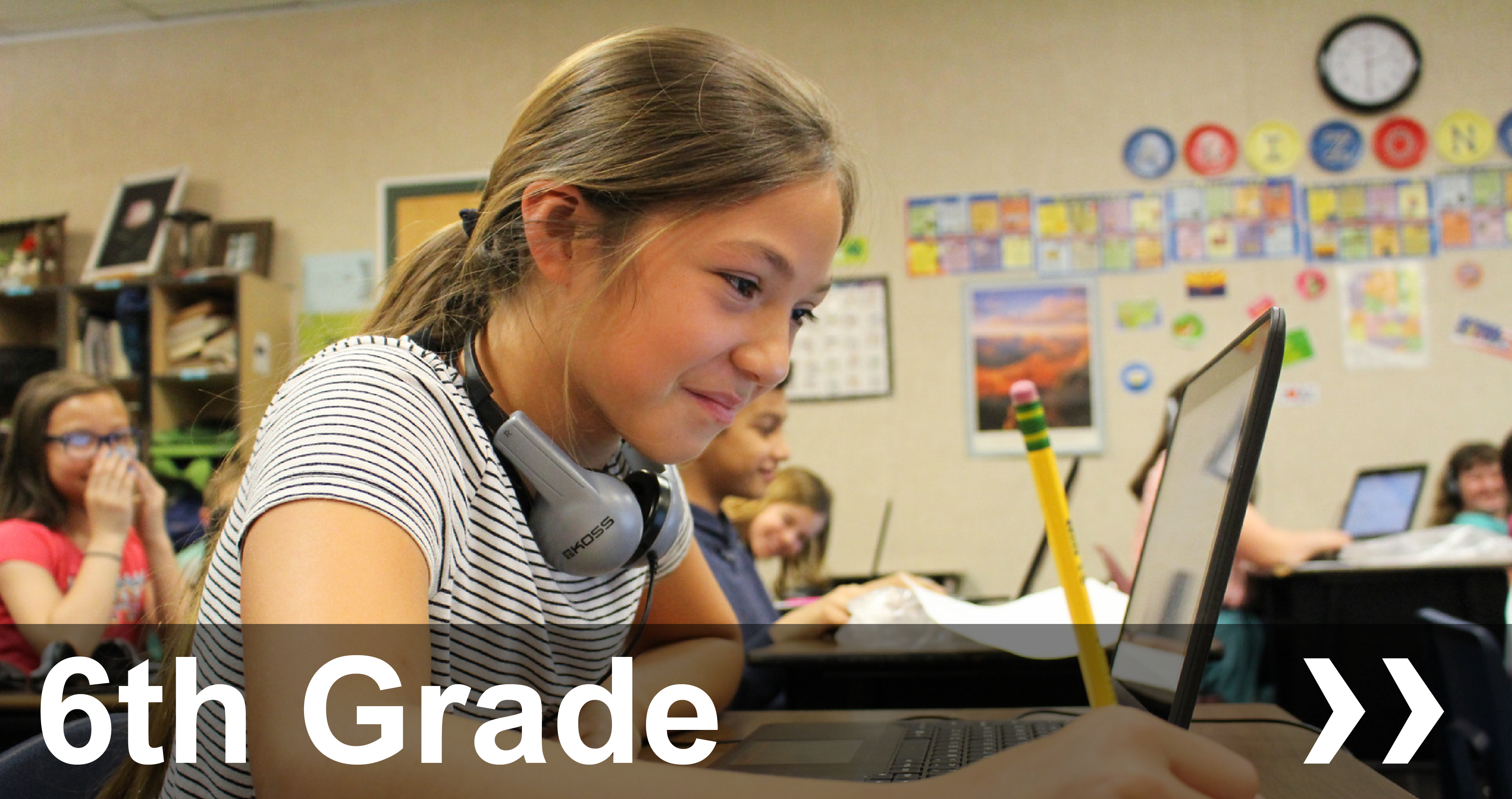 6th Grade student in front of laptop with pencil in her hand